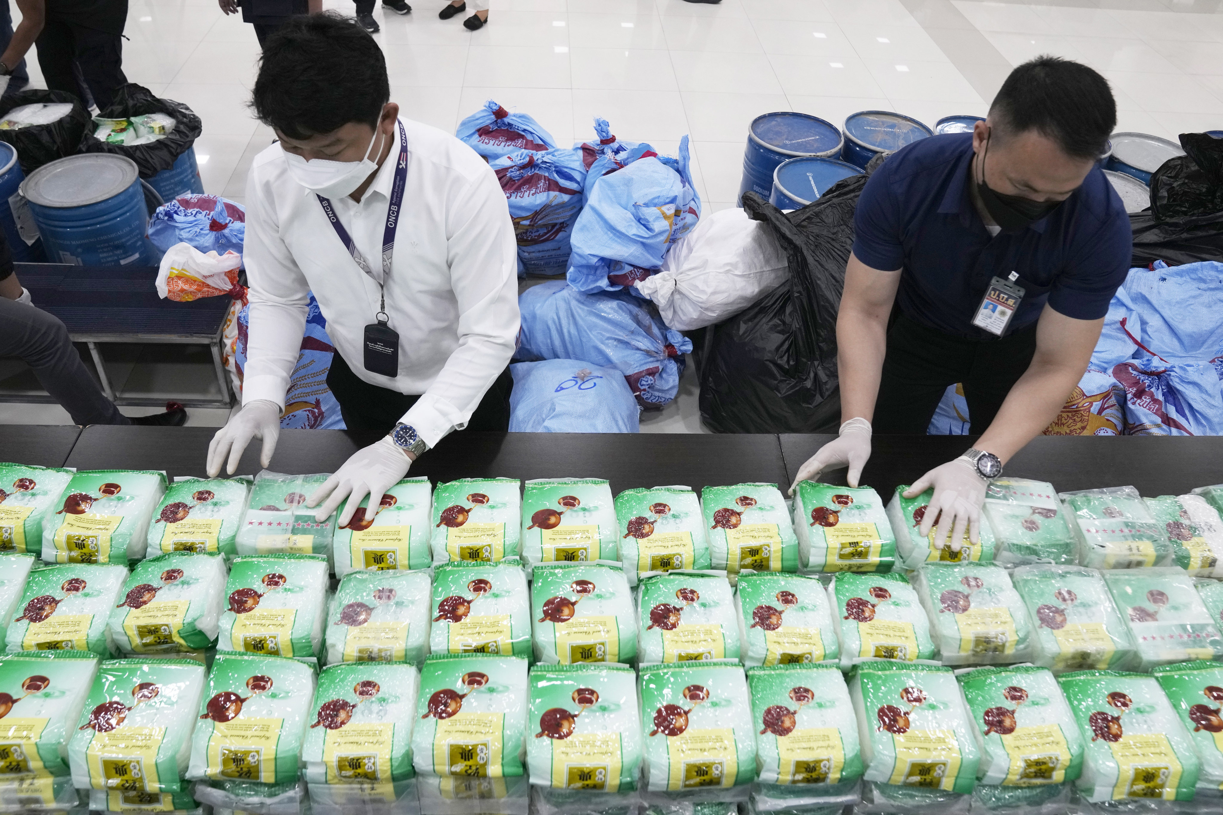 Thai officers with seized crystal meth disguised as packets of tea. Photo: AP 