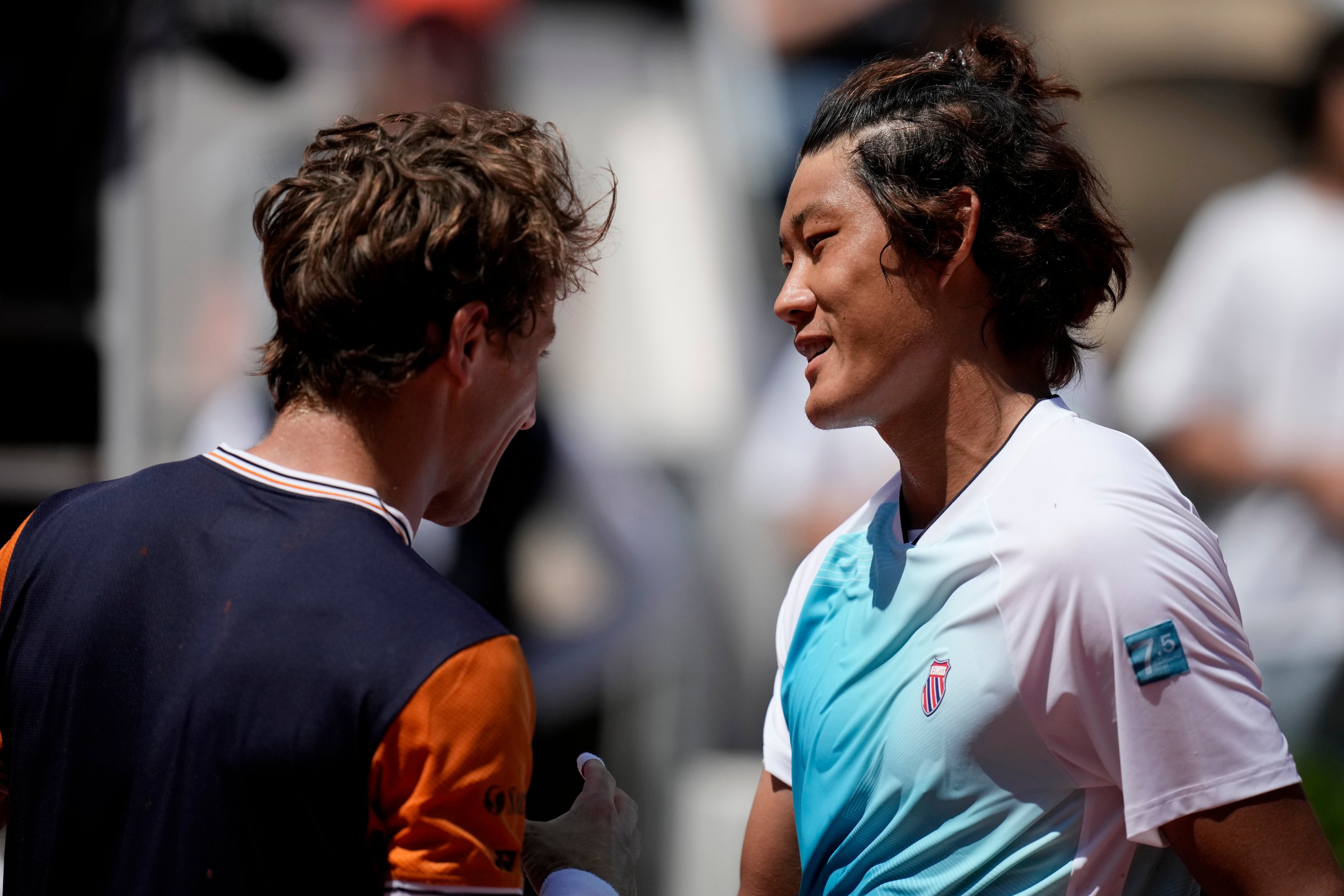 China’s Zhang Zhizhen shakes hands with Casper Ruud after their third-round match at the French Open. Photo: AP