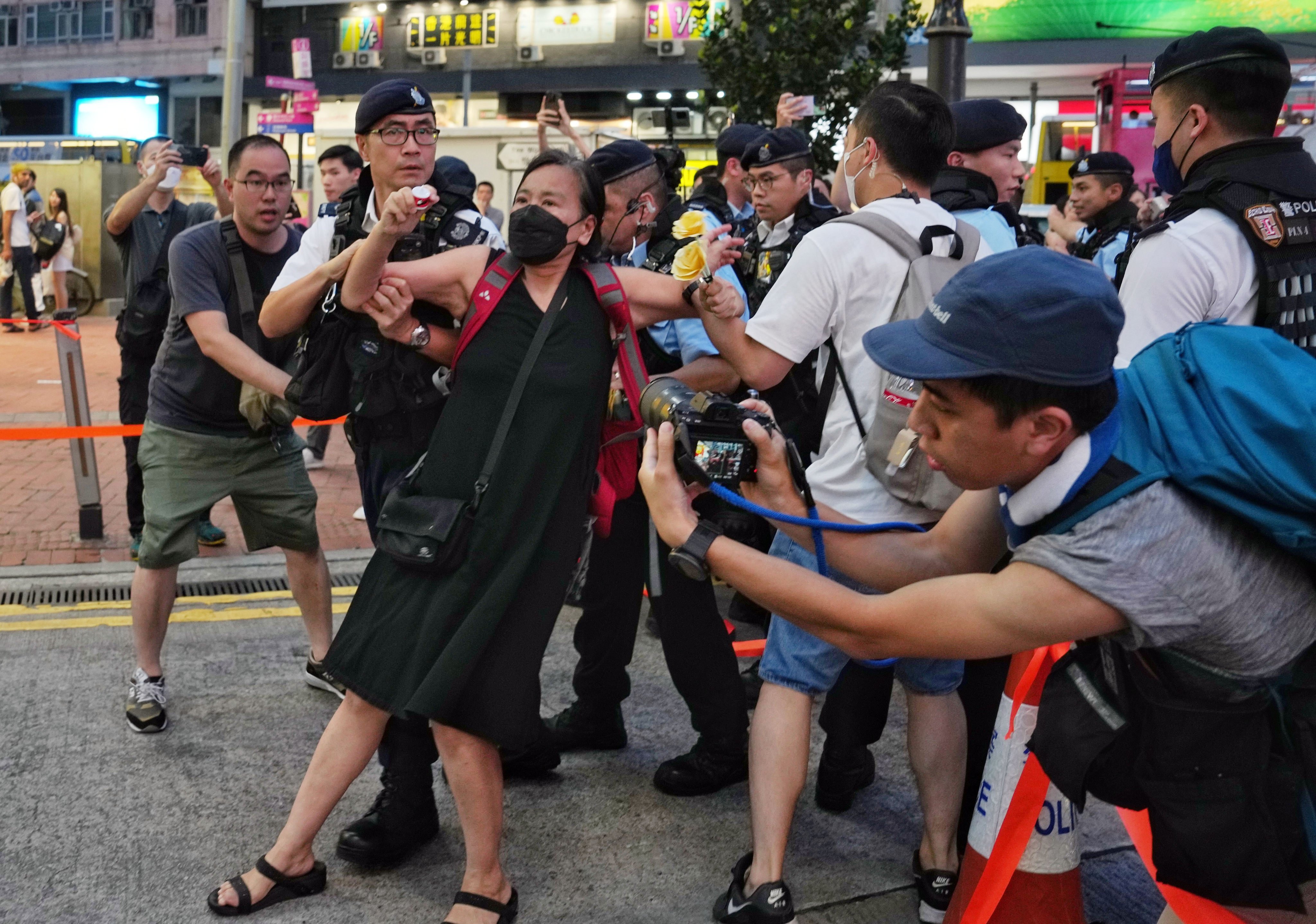 Chan Po-ying, chairwoman of the League of Social Democrats, is taken away by police in Causeway Bay on Sunday. Photo: Elson Li