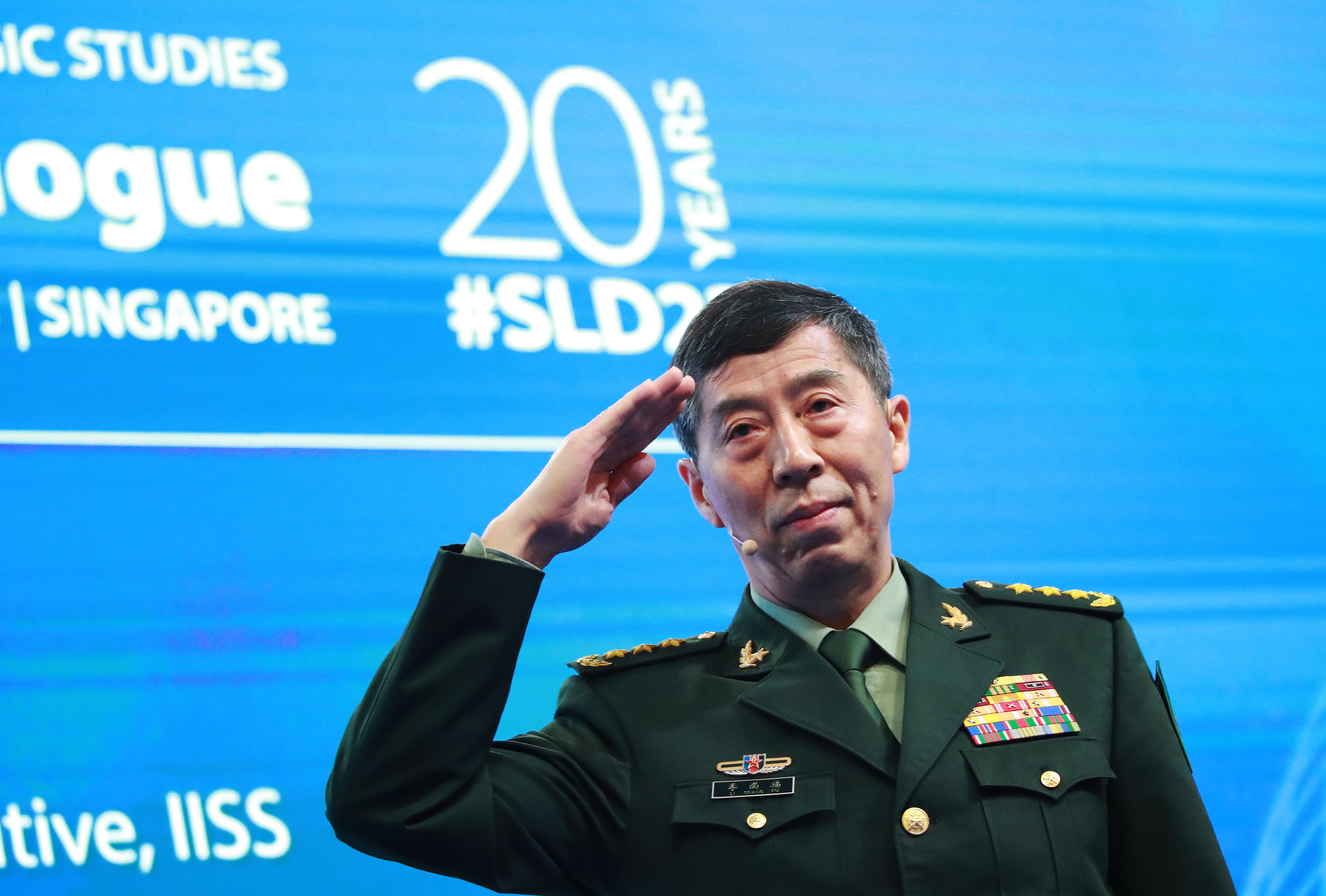 Chinese Defence Minister General Li Shangfu salutes before delivering his speech at the Shangri-La Dialogue in Singapore on Sunday. Photo: EPA