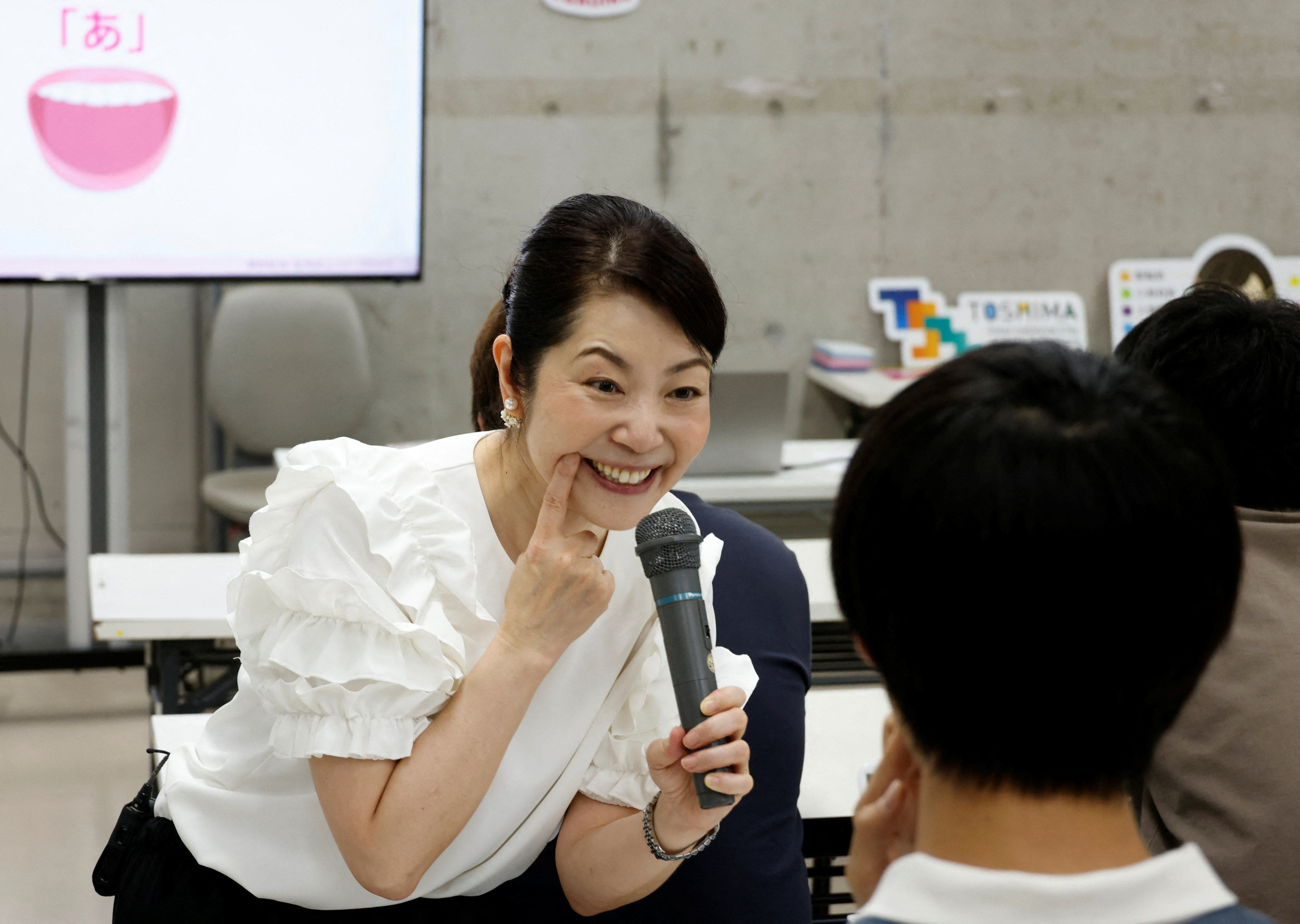 Smile coach Koike Kawano teaches students at a smile training course at Sokei Art School in Tokyo last month. Photo: Reuters