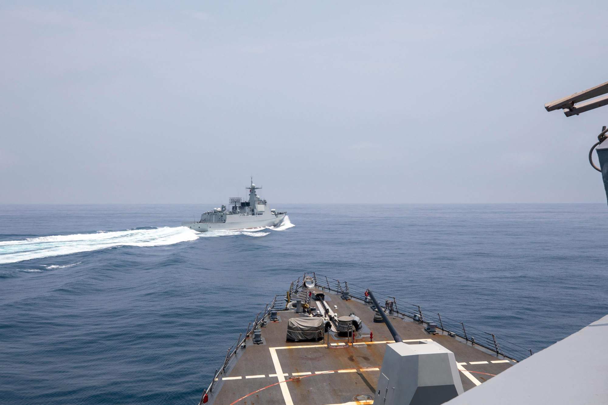 This handout photo taken on Saturday shows the Arleigh Burke-class guided-missile destroyer USS Chung-Hoon (foreground) observing the Chinese PLA Navy vessel Luyang III while transiting the Taiwan Strait with the Royal Canadian Navy’s HMCS Montreal. Photo: US Navy via AFP