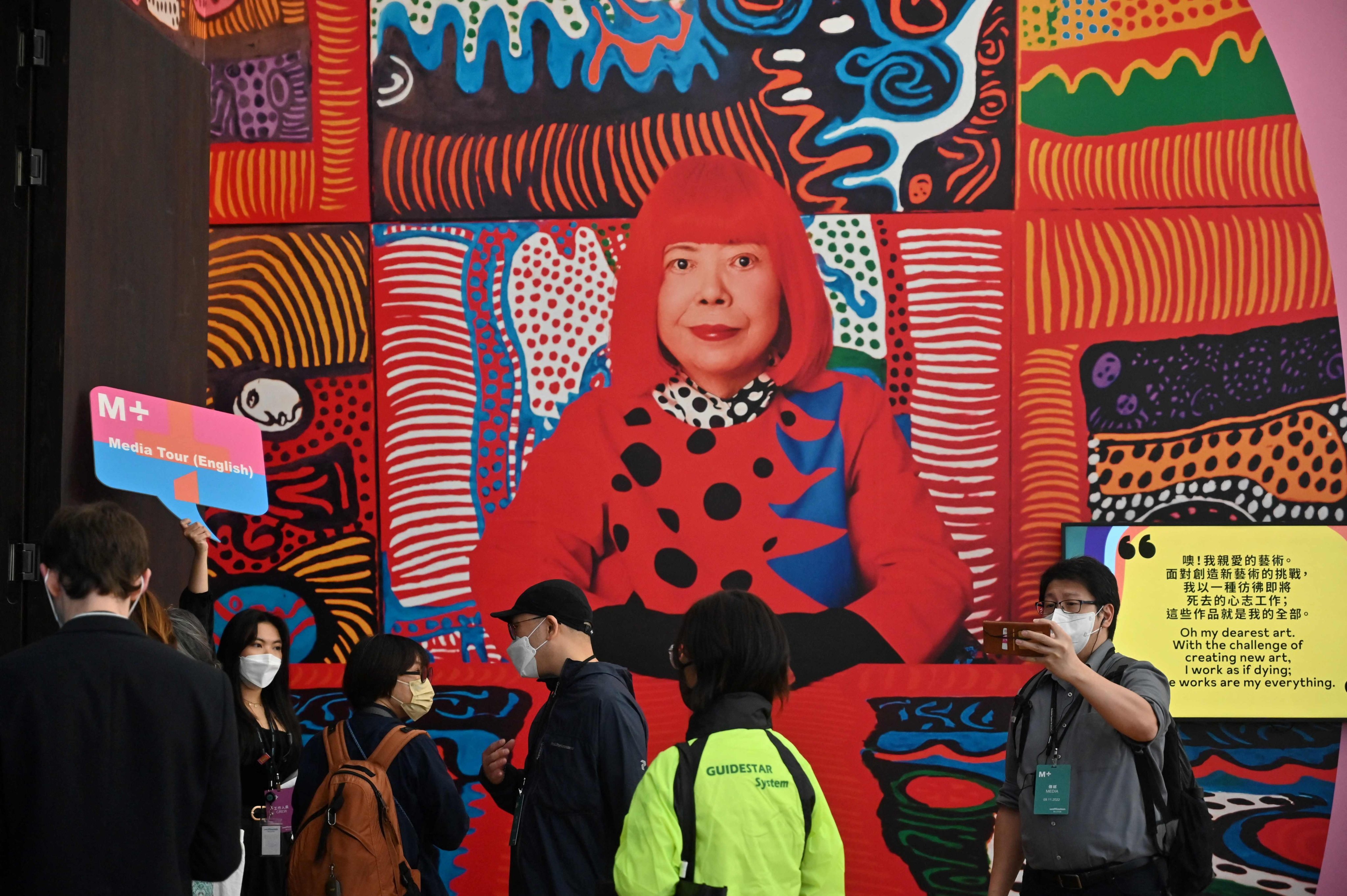 Members of the media attend a press preview tour of the Yayoi Kusama exhibition at M+ art museum in Hong Kong. Photo: AFP