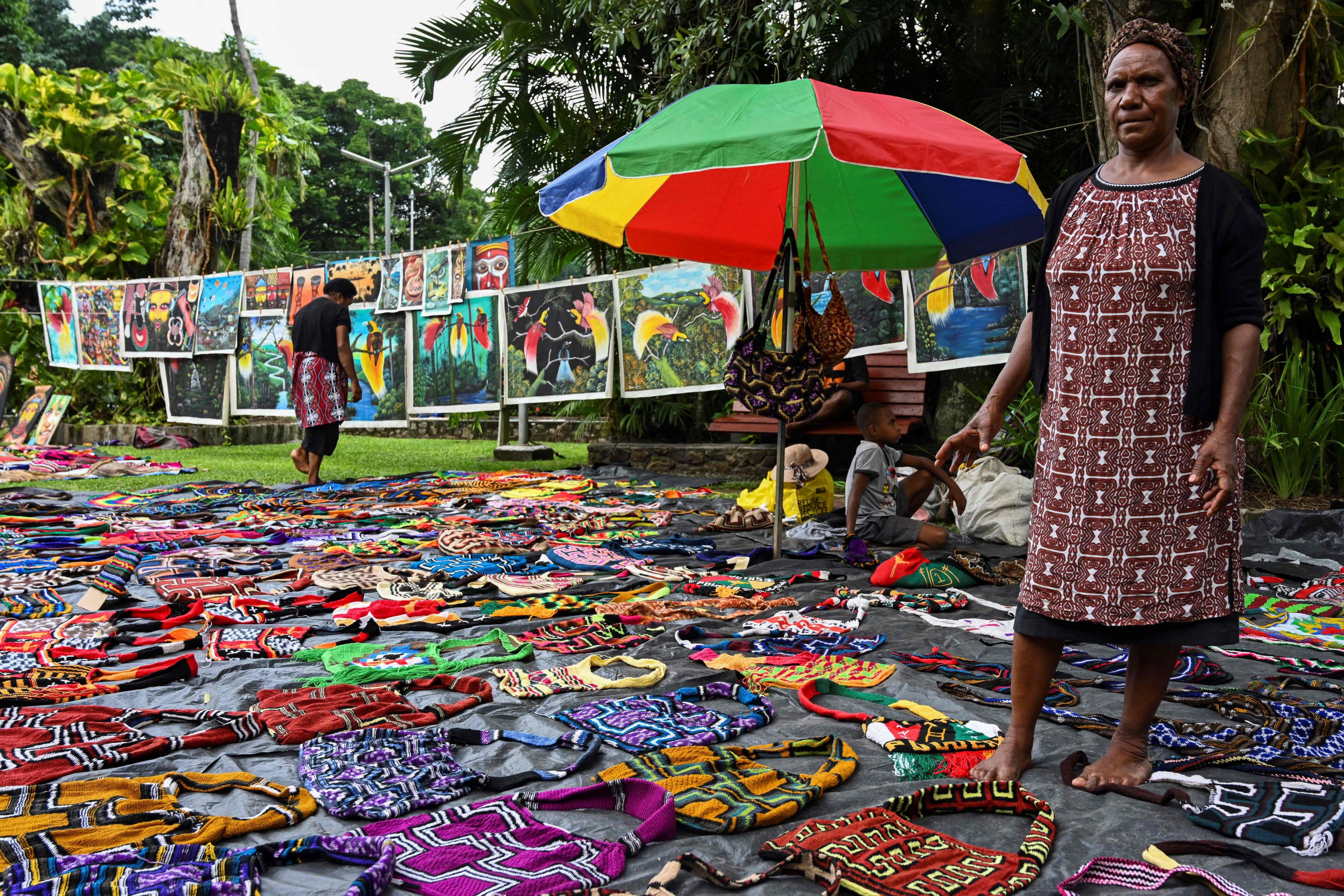 A woman selling traditional Papua New Guinean “Bilum” bags at a craft market in Port Moresby. The word bilum means “womb” in the local Tok Pisin language. Photo: AFP