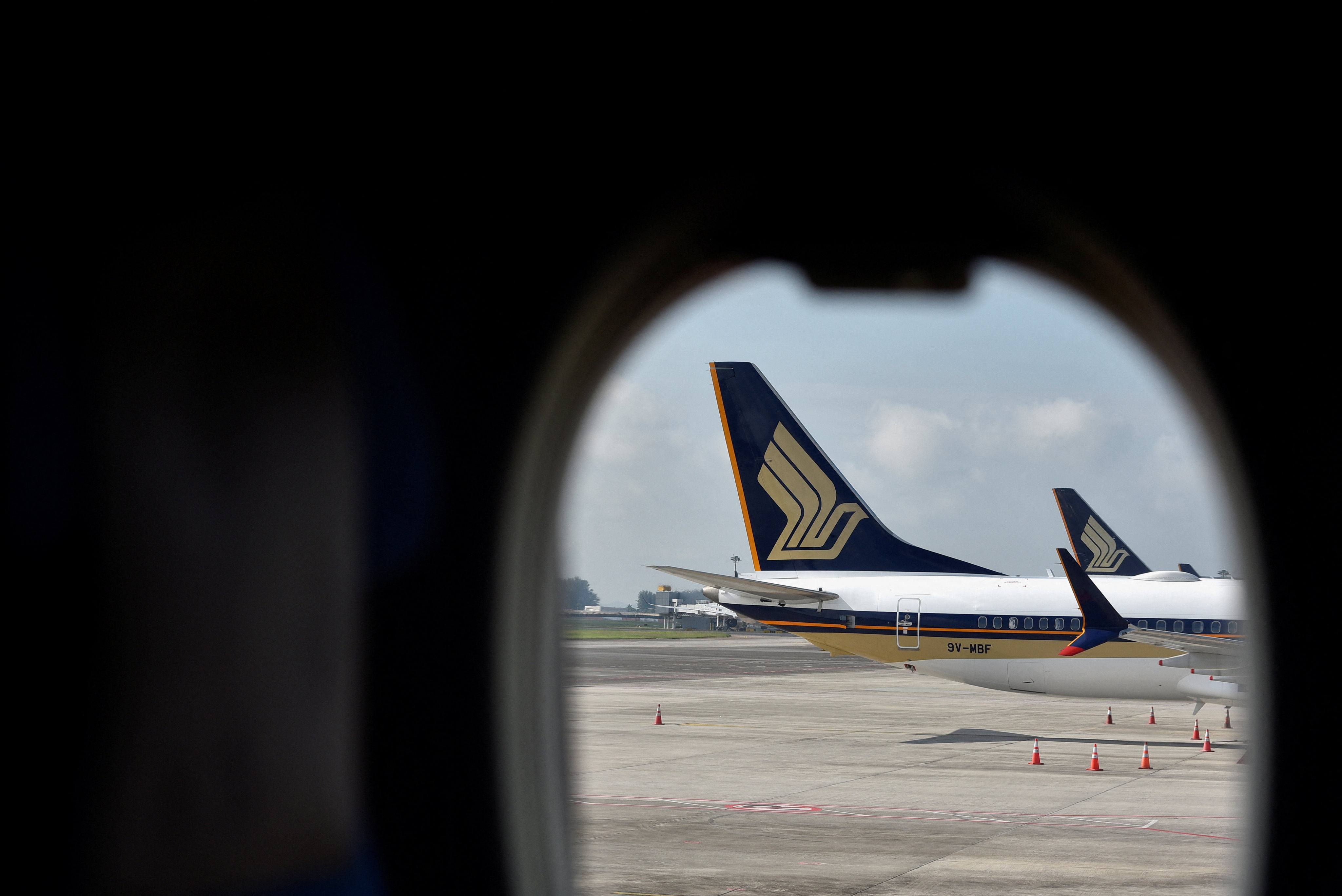 Singapore Airlines planes sit on the tarmac at Changi Airport. On most airlines, in-air internet typically remains exclusive to those who shell out for a first-class or business traveller seat. Photo: Reuters