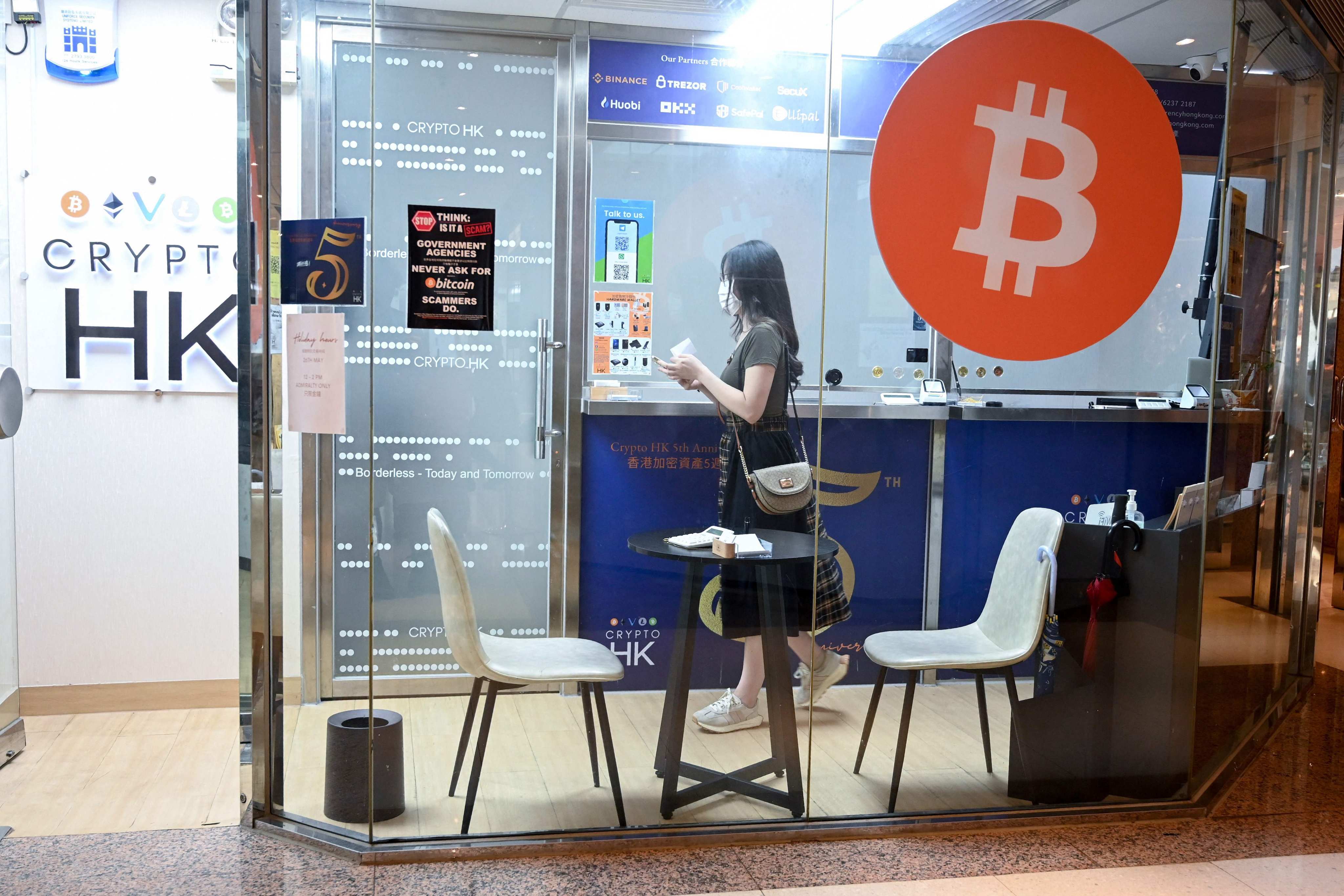 A woman in a cryptocurrency exchange office in Hong Kong. Photo: AFP