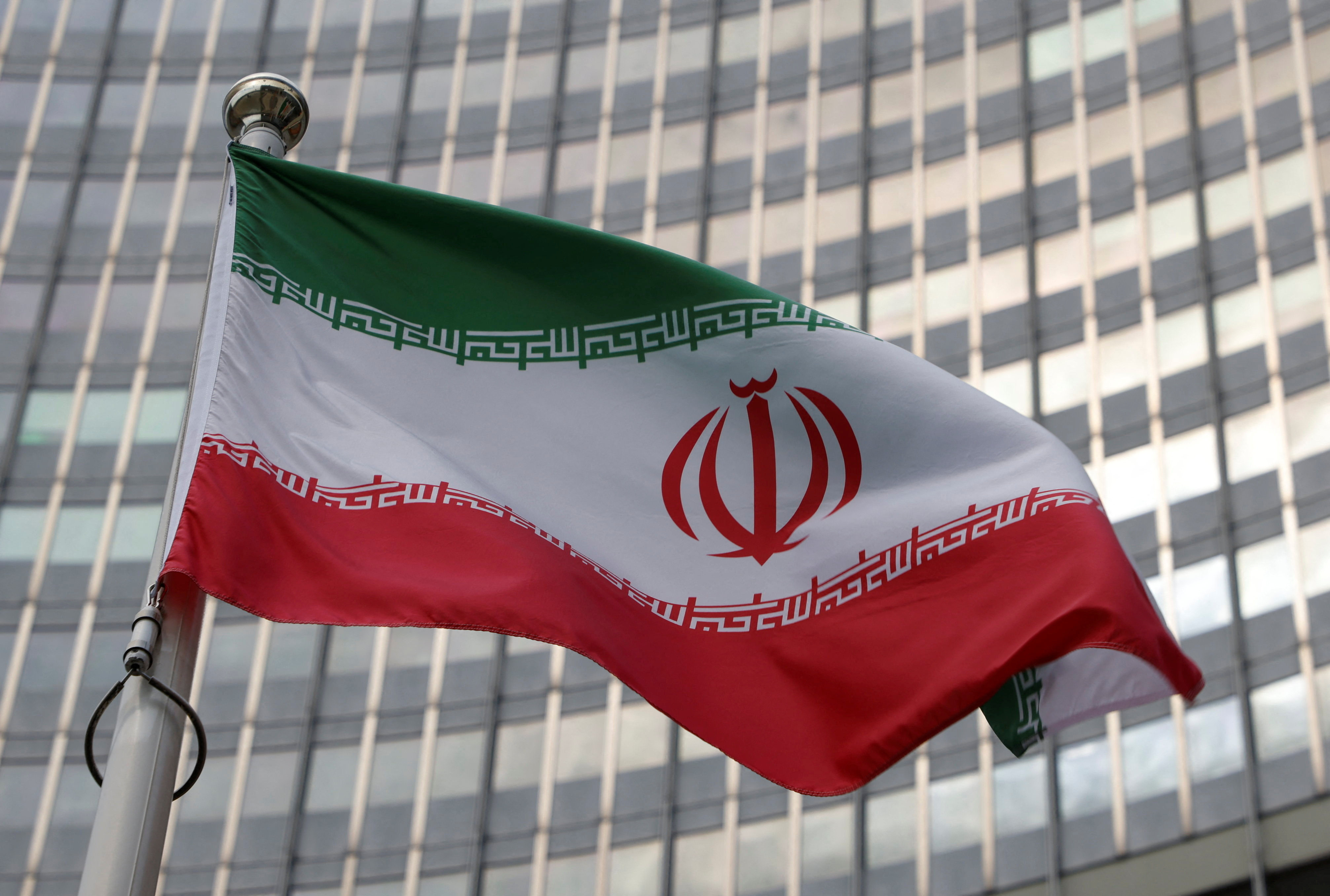 The Iranian flag flutters in front of the International Atomic Energy Agency headquarters in Vienna, Austria on Monday. Photo: Reuters