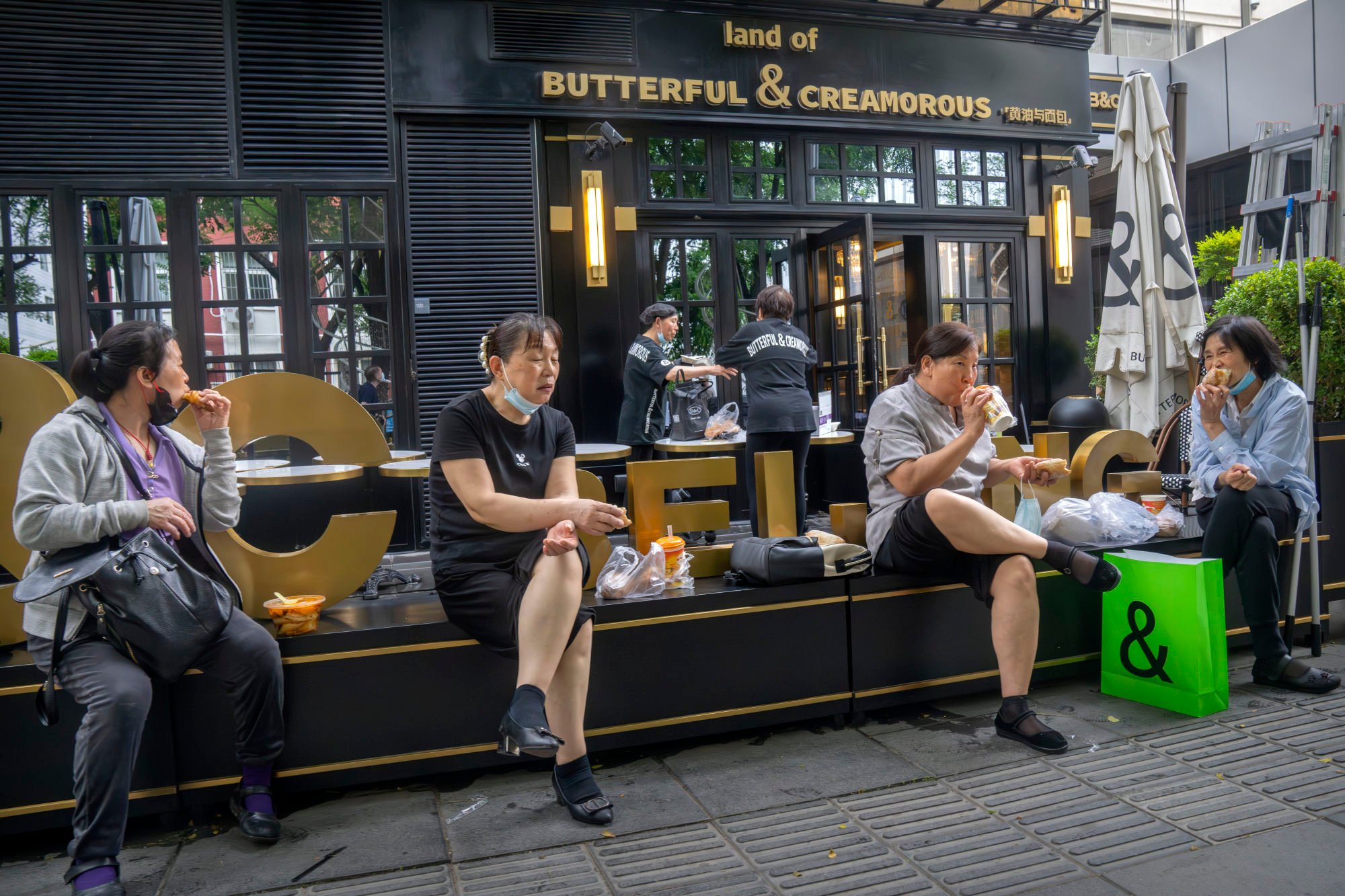 People sit outside a bakery at a shopping mall in Beijing. Photo: AP Photo