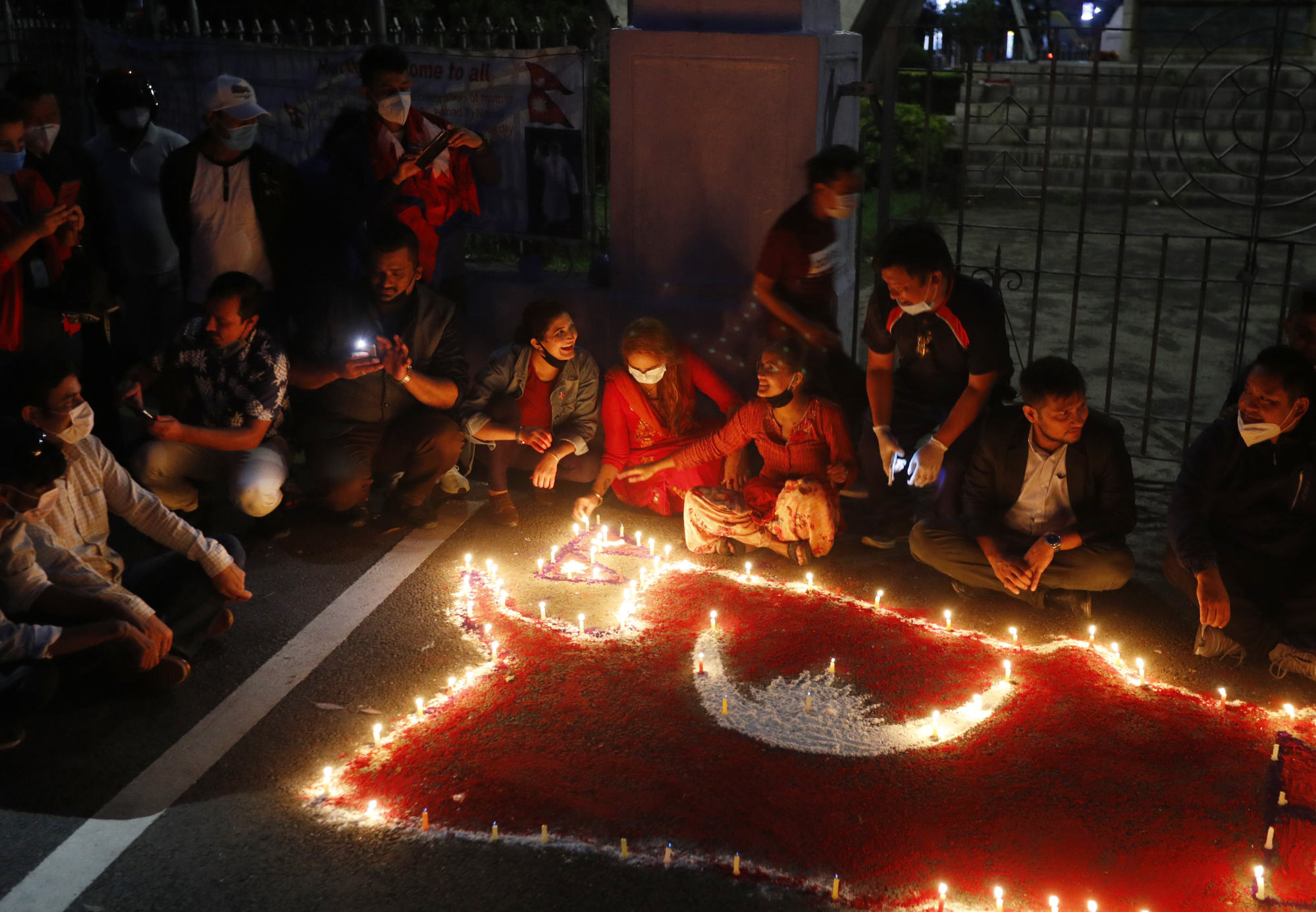 People light candles on an outline of the new map of Nepal drawn on a road as they celebrate the approval of the political map to include territory claimed by both India and Nepal, in Kathmandu, Nepal, in June 2020. Photo: AP