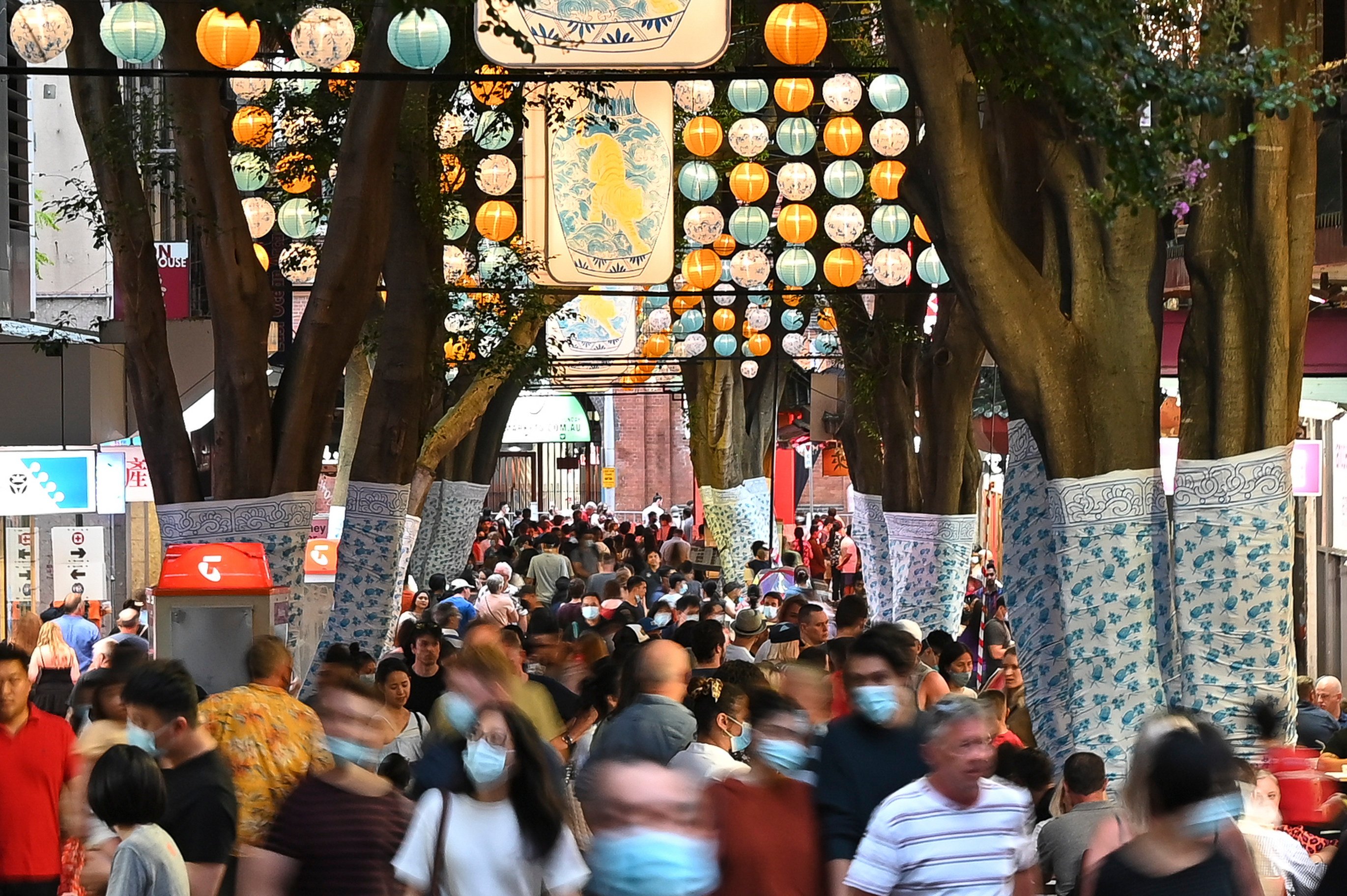 Crowds flock to Dixon Street in Sydney’s Chinatown ahead of Lunar New Year in 2022. Even as the Australian government tries to put out the welcome mat for long-term visitors and migrants, the country’s long struggle with discrimination might colour the experience of many new arrivals. Photo: Getty Images