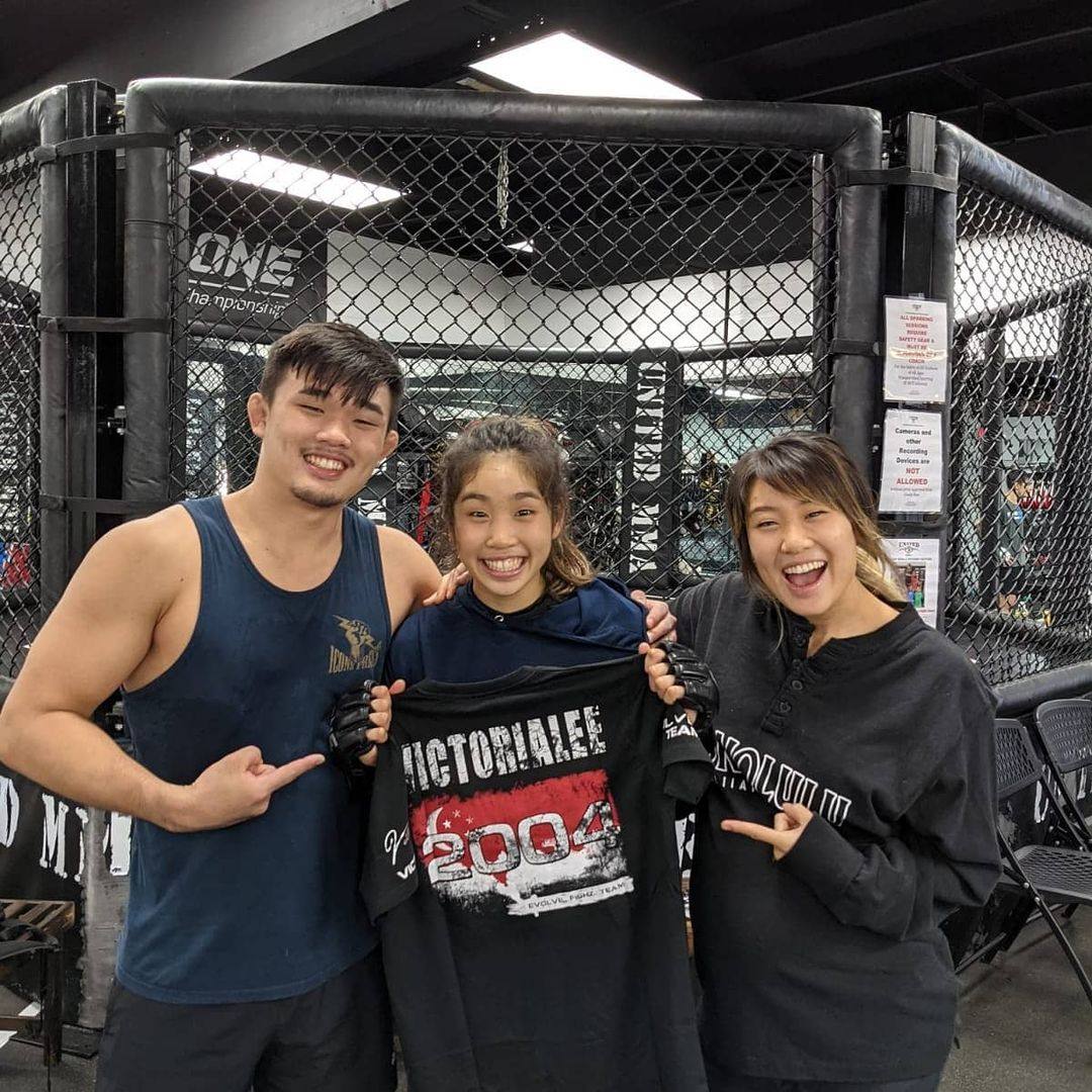 Christan Lee (left) and Angela Lee (right) celebrate with younger sister Victoria Lee after she signs with Evolve MMA. Photo: Instagram