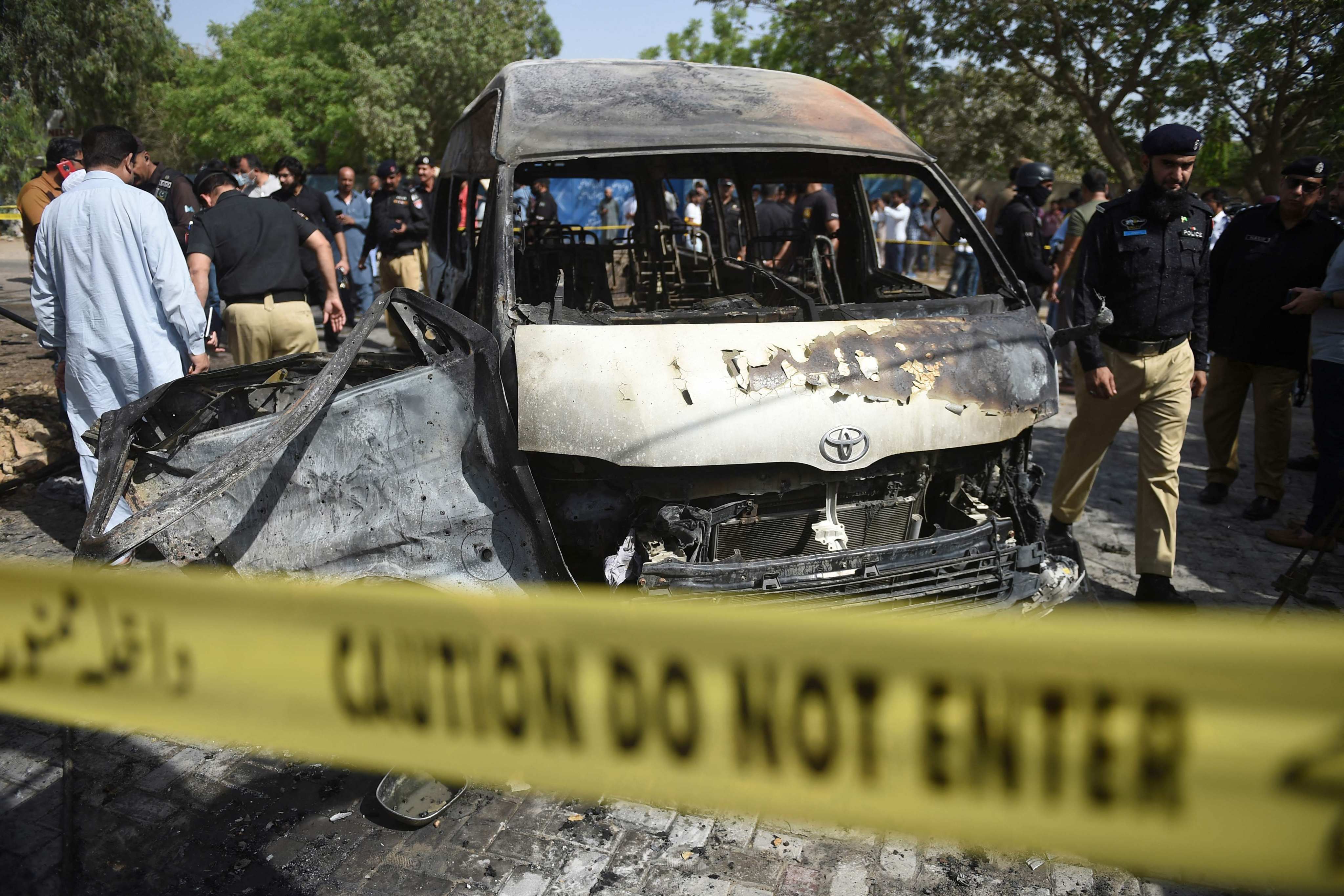Pakistani police inspect a site around damaged vehicles following a deadly suicide bombing near the Confucius Institute affiliated with Karachi University in August last year. Three Chinese nationals were among the four people killed. Photo: AFP 