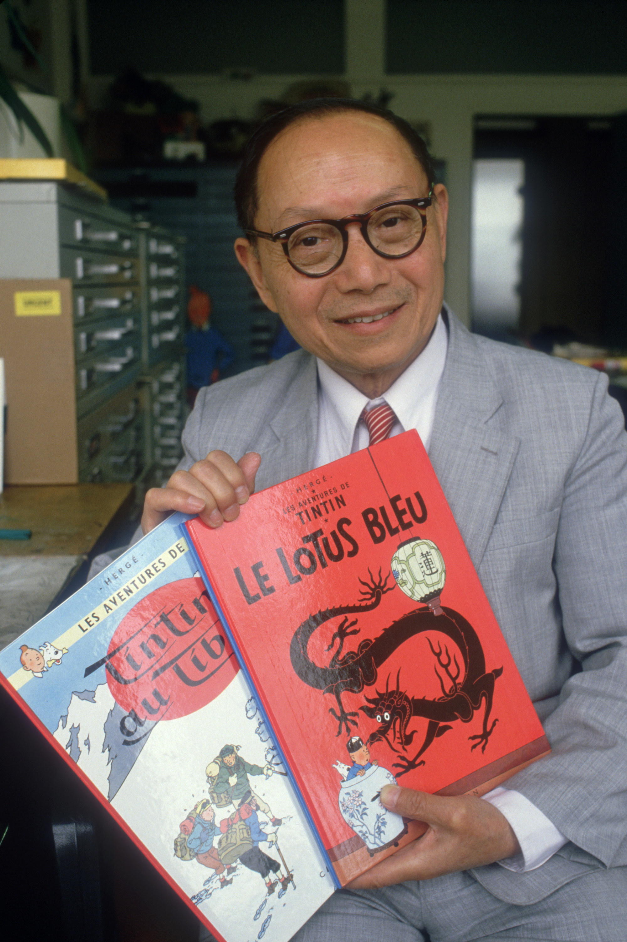 Zhang holds copies of The Blue Lotus and Tintin in Tibet. Photo: Getty Images