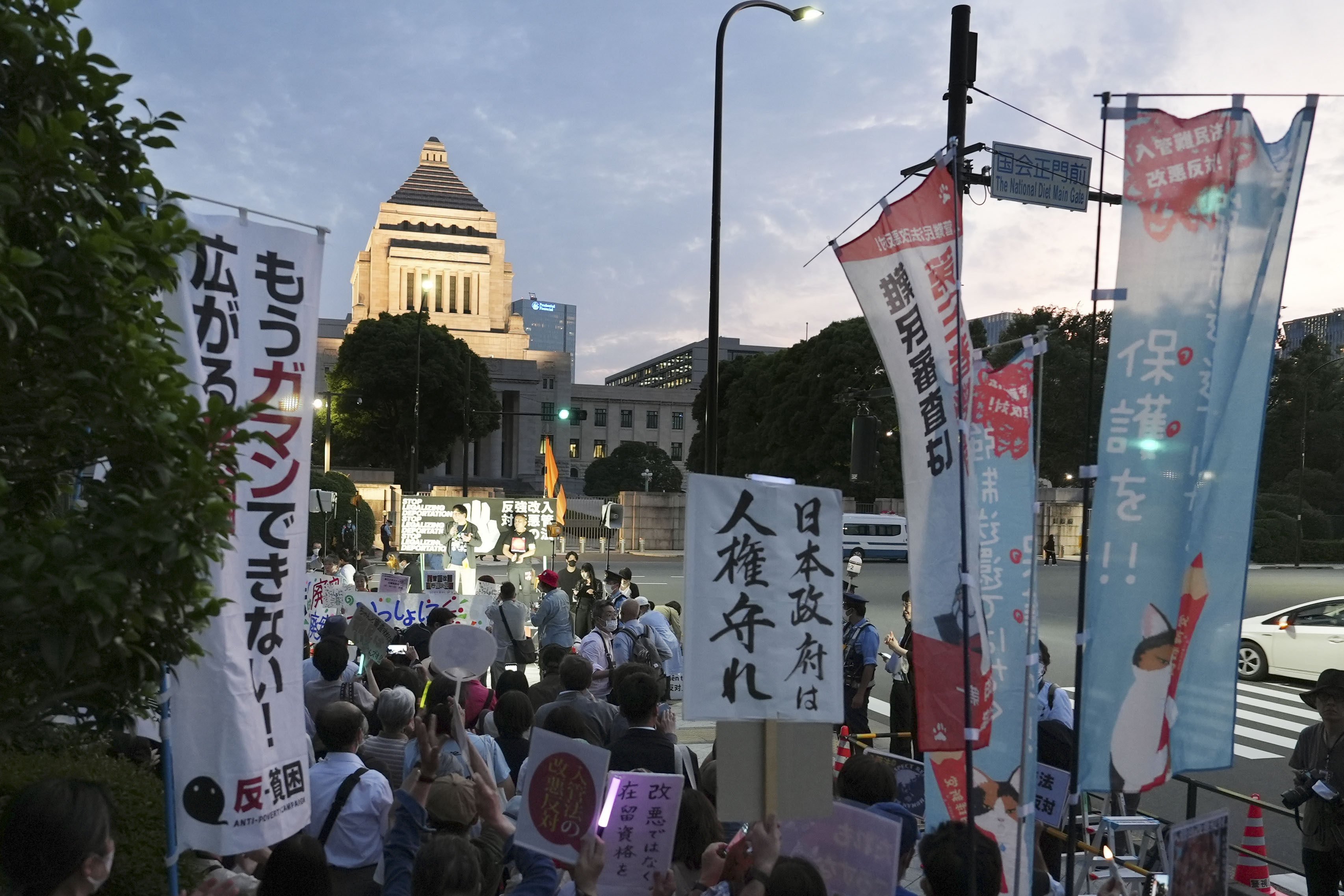 People rally in front of the Diet building in Tokyo on June 5 in opposition to the controversial bill to amend an immigration law enabling authorities to deport individuals who repeatedly apply for refugee status. The harsher measures come as the global refugee situation has worsened worldwide. Photo: Kyodo