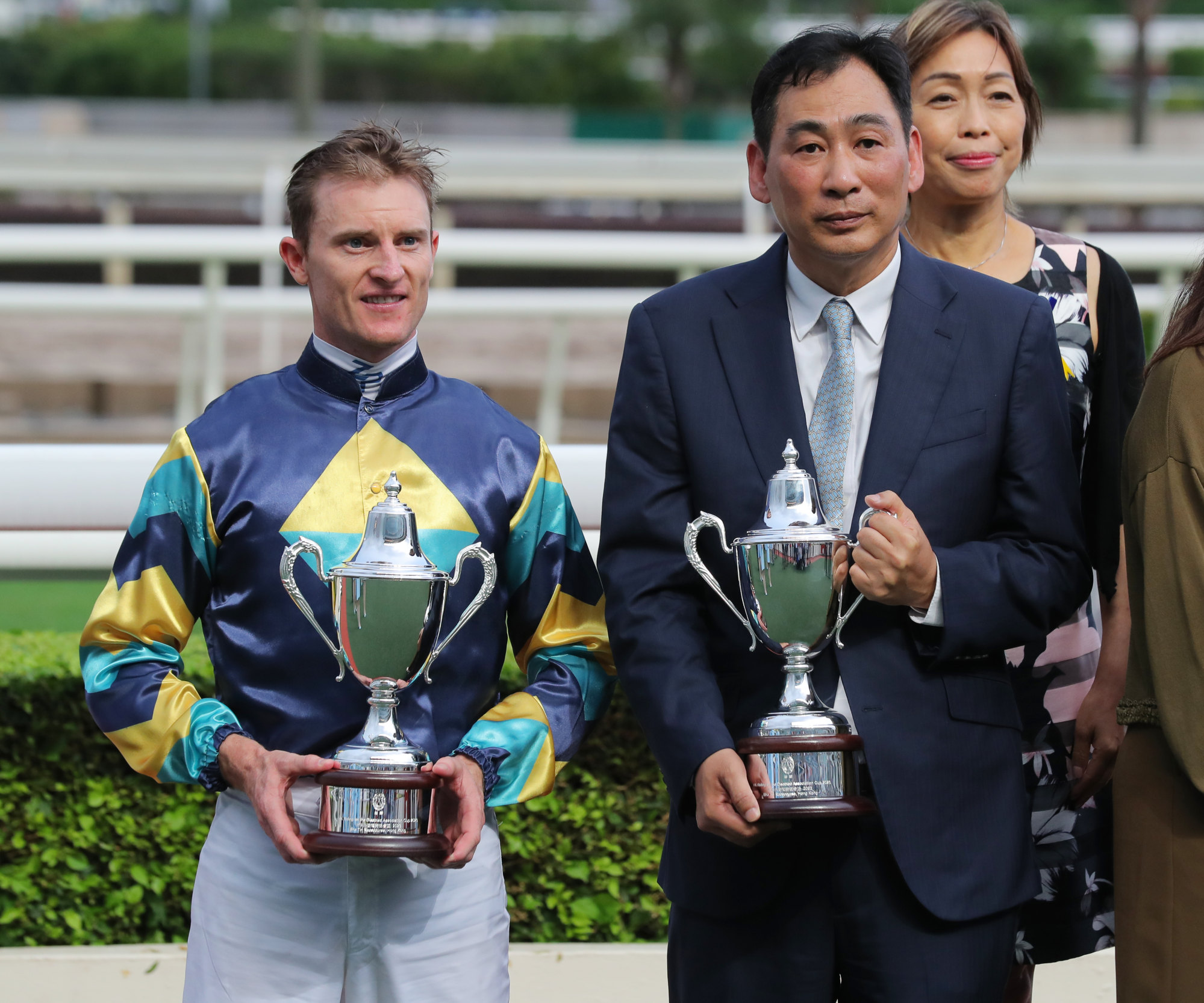 Zac Purton and Michael Chang receive their Class Four Hong Kong Riding Association For The Disabled Cup trophies.