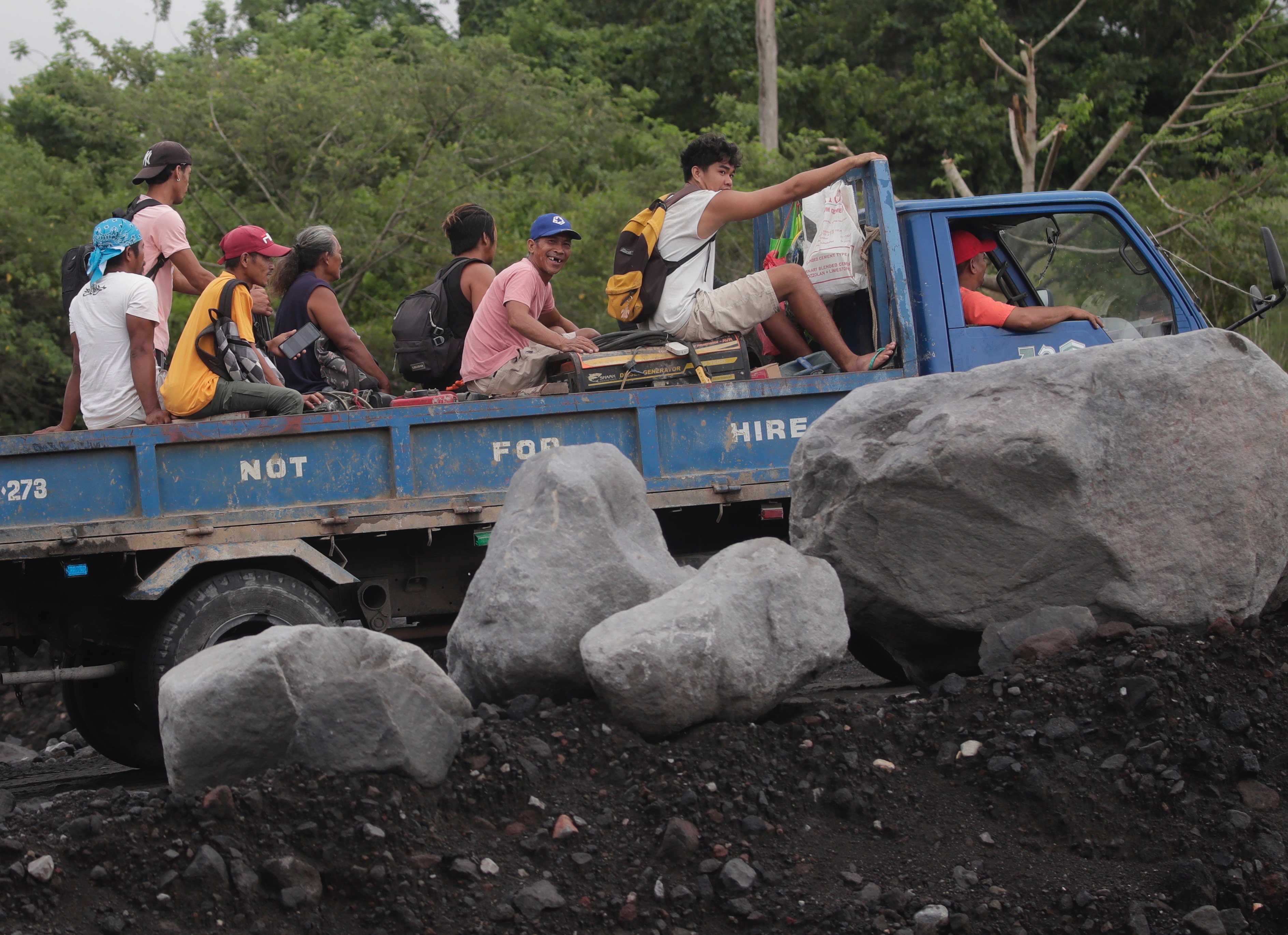 Villagers living in a volcano’s danger zone in the Philippines ride a truck during a mass evacuation in Albay province on Sunday. Photo: EPA-EFE