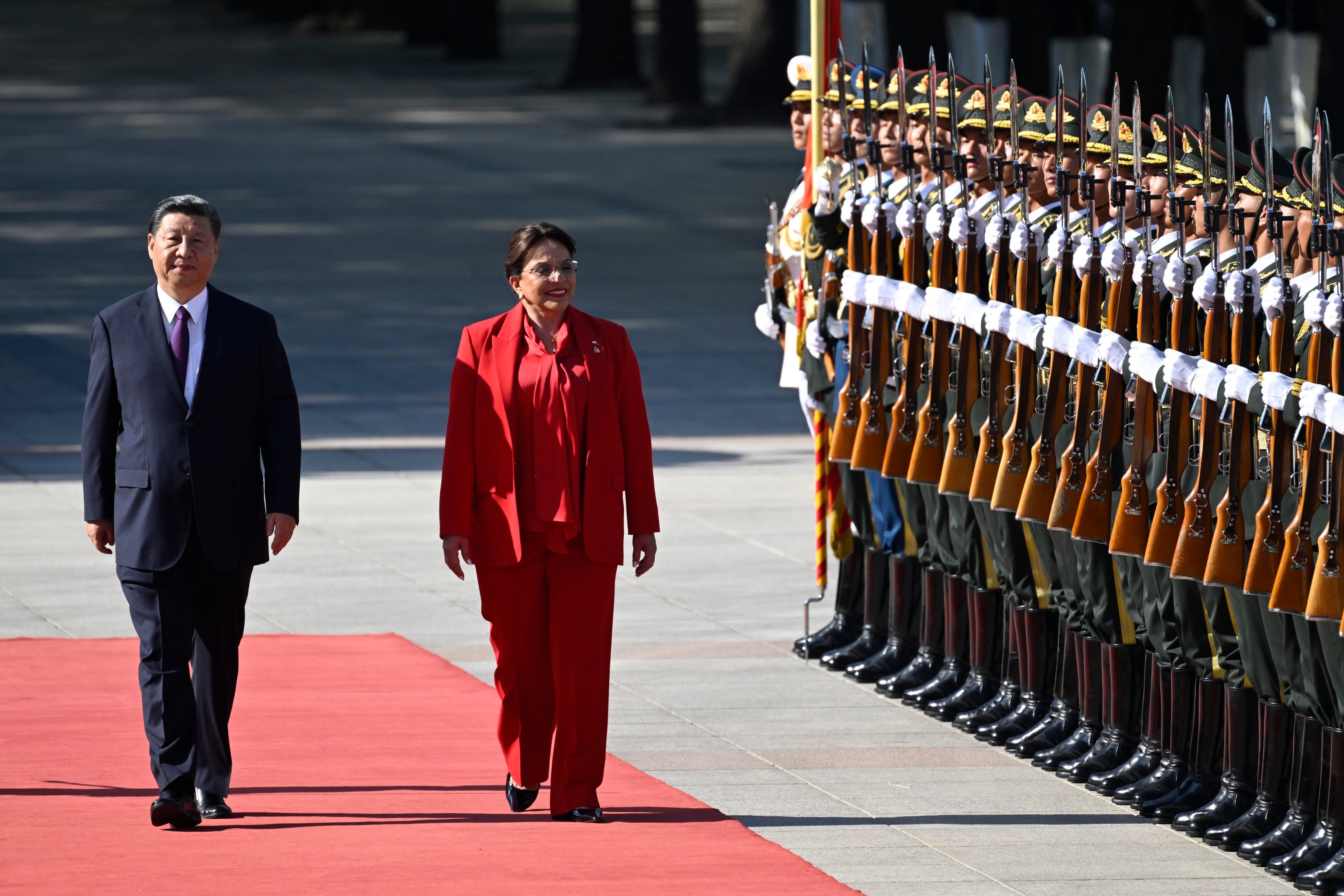 Honduran President Xiomara Castro (right) and Chinese President Xi Jinping walk down the red carpet outside the Great Hall of the People in Beijing on Monday. Photo: AP