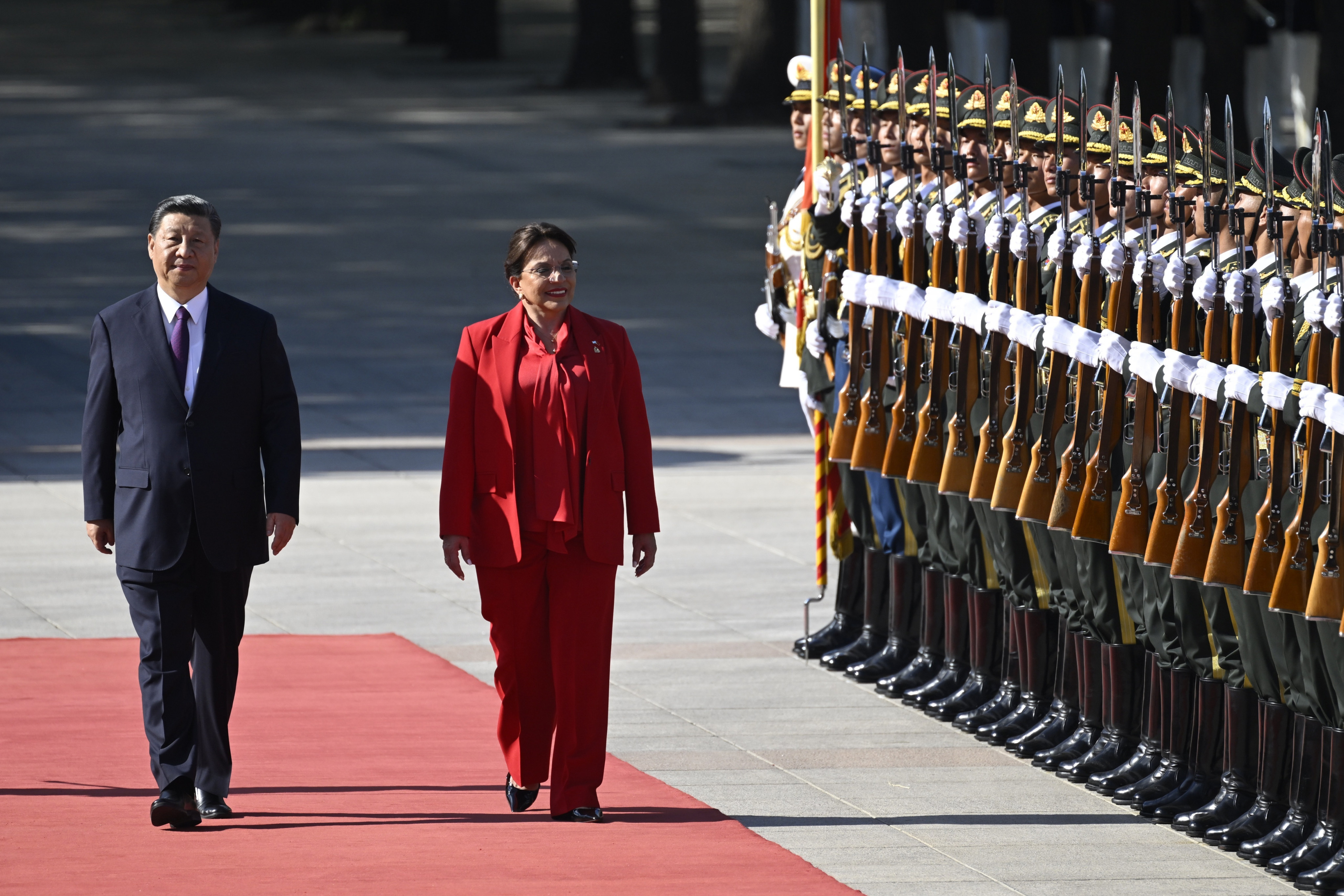 Honduran President Xiomara Castro (right) and Chinese President Xi Jinping walk down the red carpet outside the Great Hall of the People in Beijing on Monday. Photo: AP