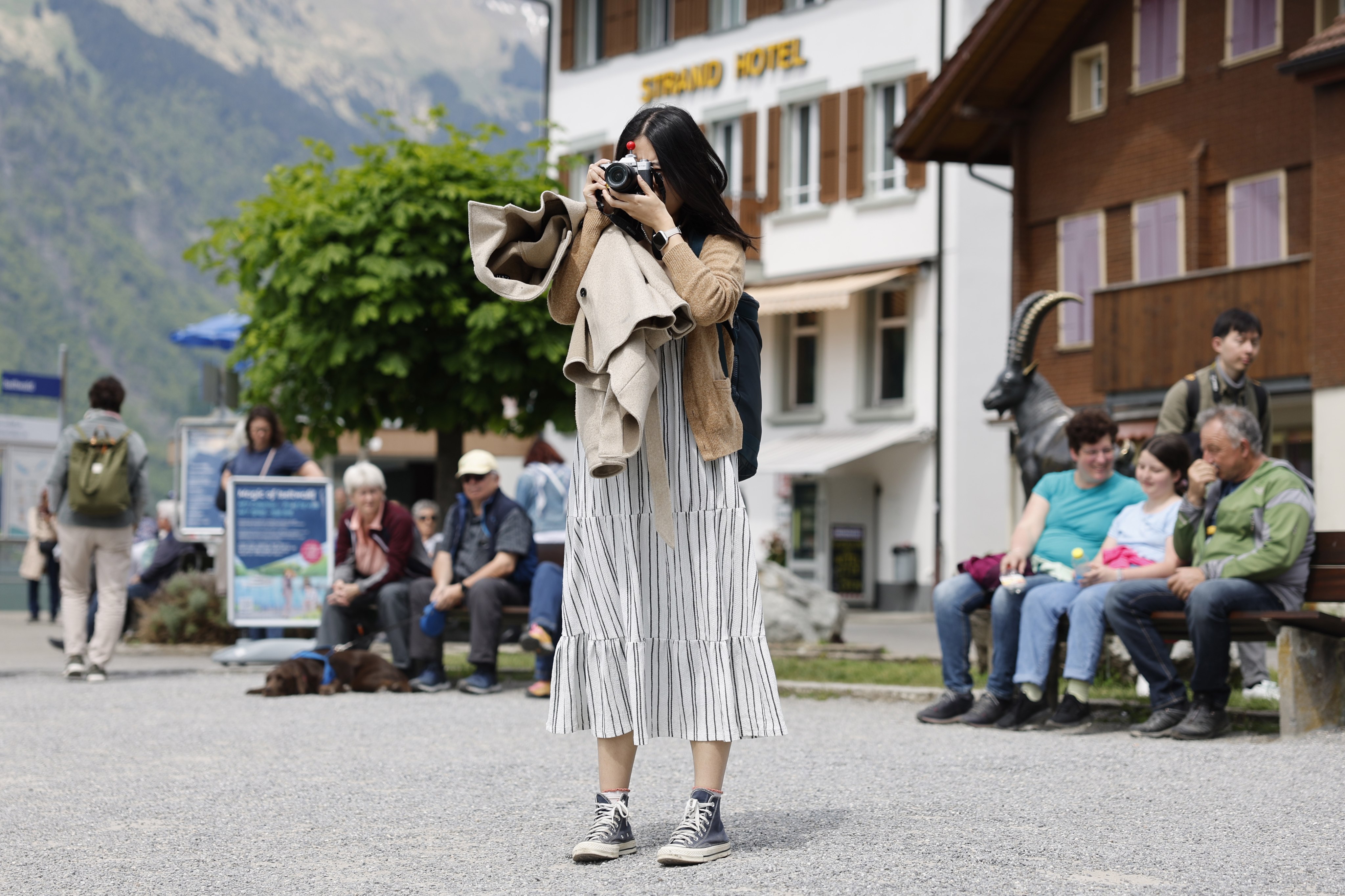 A Korean visitor takes pictures in Iseltwald, Switzerland. Photo: EPA