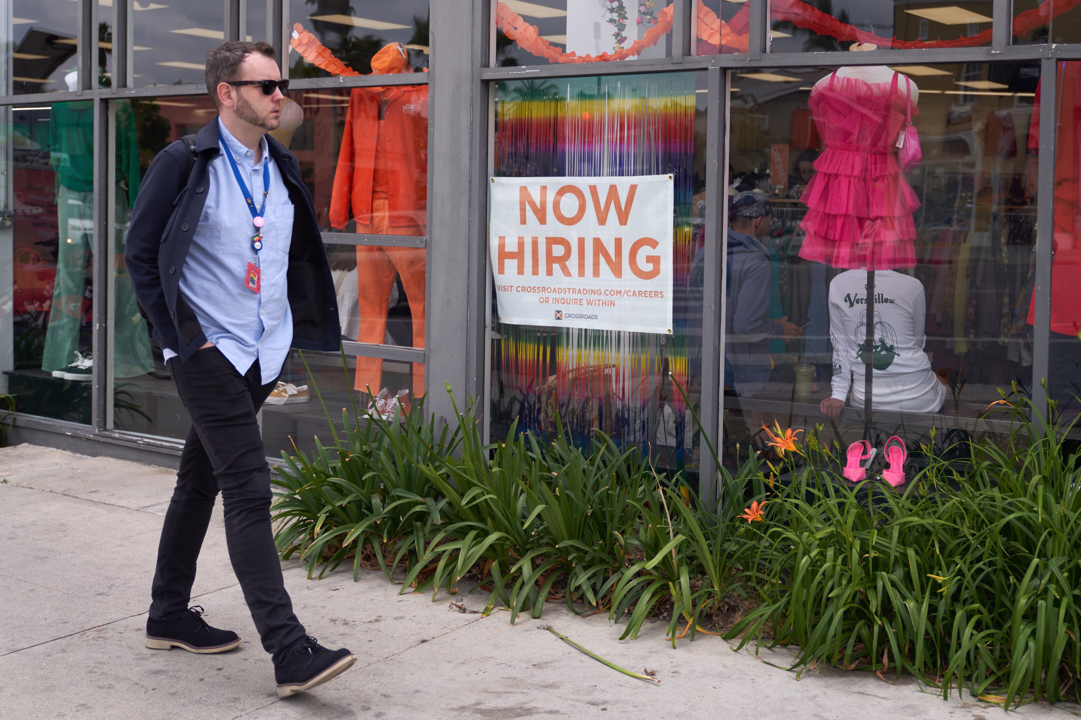 A man walks by a job advert in the window of a business in Los Angeles on June 6. The recent US Bureau of Labor report showed the public and private sector added 339,000 jobs in May despite the Federal Reserve’s aggressive interest rate increases in an attempt to lower inflation.  Photo: EPA-EFE