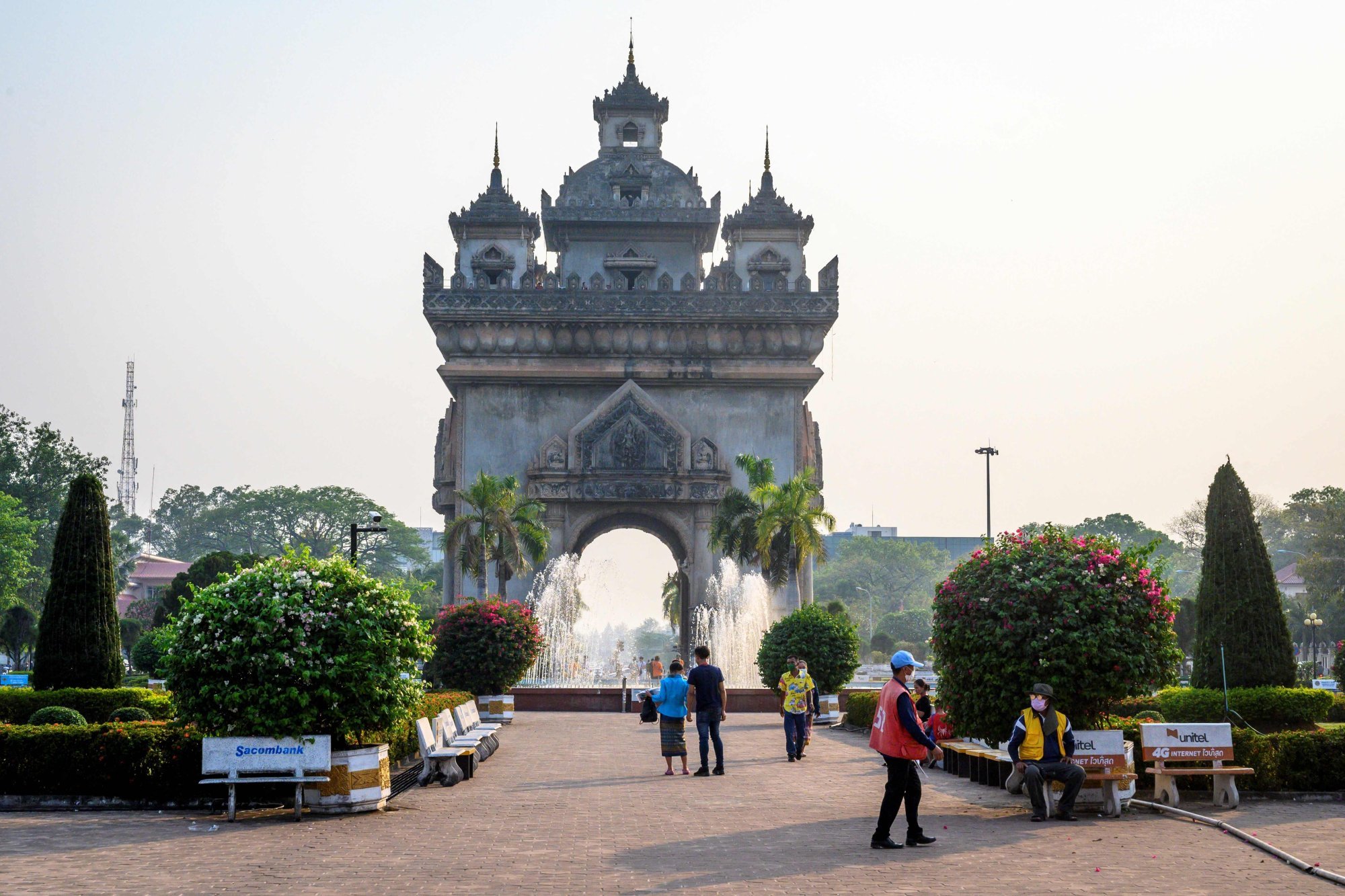 People walk by a war monument in the Laotian capital Vientiane. The average person from Laos is 155.89cm tall. Photo: AFP