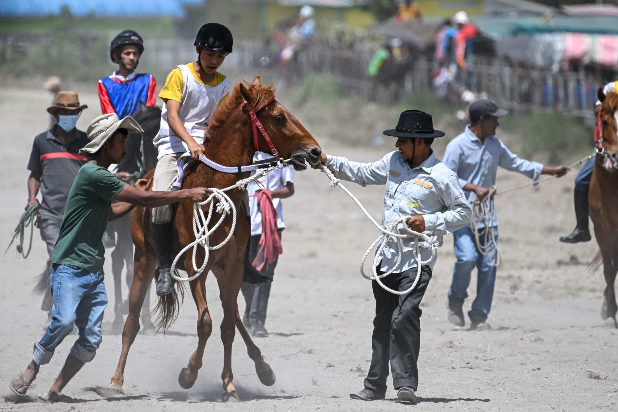 People assist a young jockey and his mount before a traditional horse race in Indonesia’s Aceh province on Monday. Indonesian men are 163.55cm tall on average. Photo: AFP