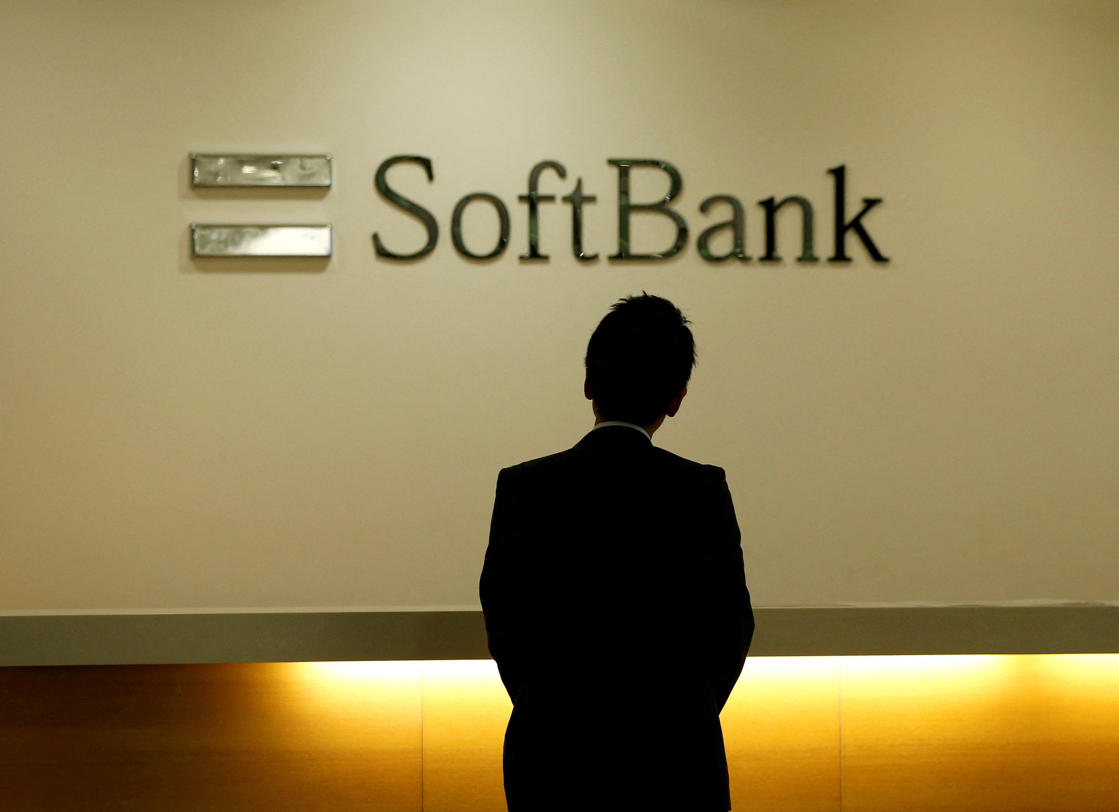 A man looks at the logo of SoftBank Group Corp at the company’s headquarters in Tokyo on June 30, 2016. Photo: Reuters