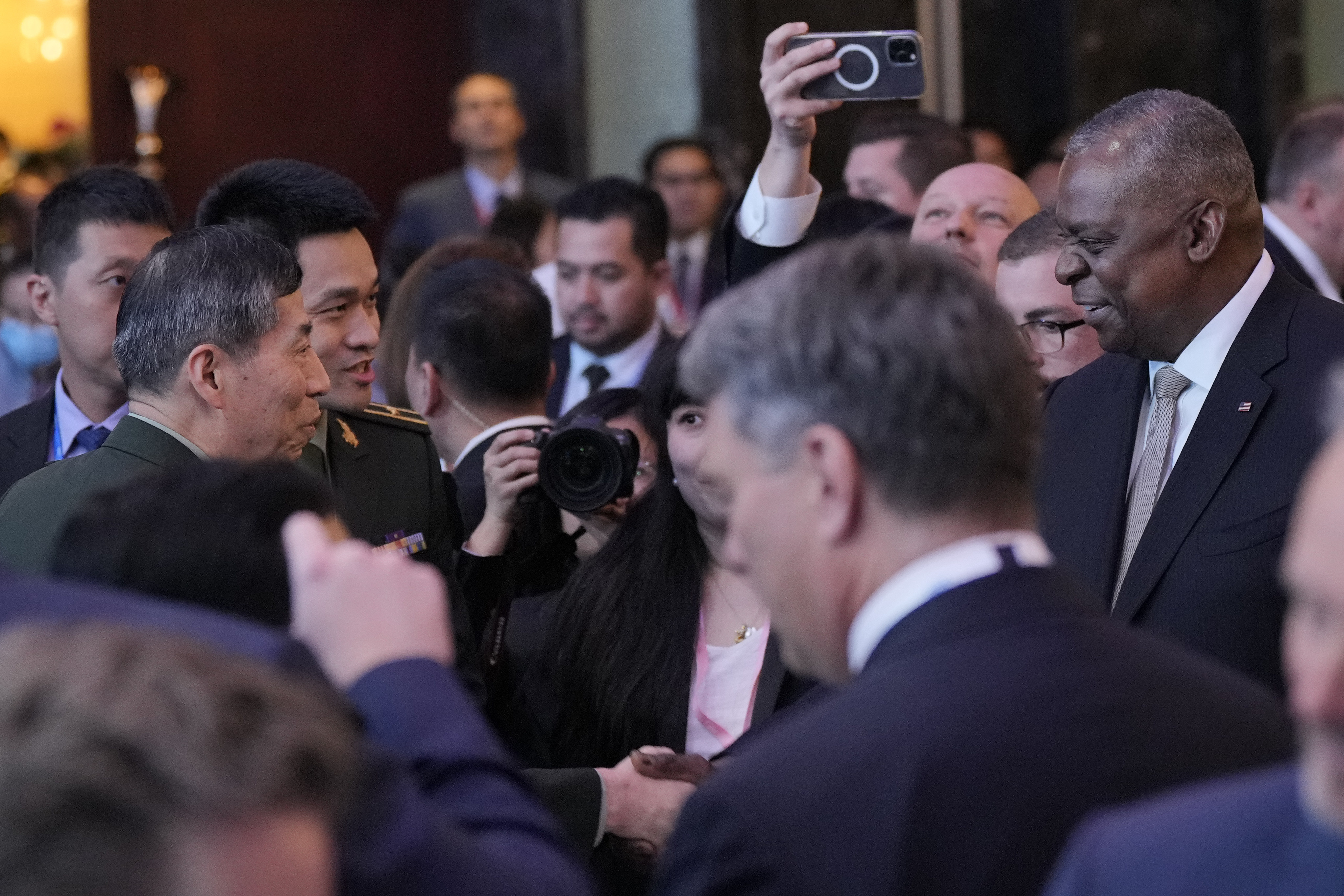 US Defence Secretary Lloyd Austin (right) shakes hands with Chinese Defence Minister Li Shangfu (left) at the opening dinner of the Shangri-La Dialogue in Singapore on June 2. Photo: AP 