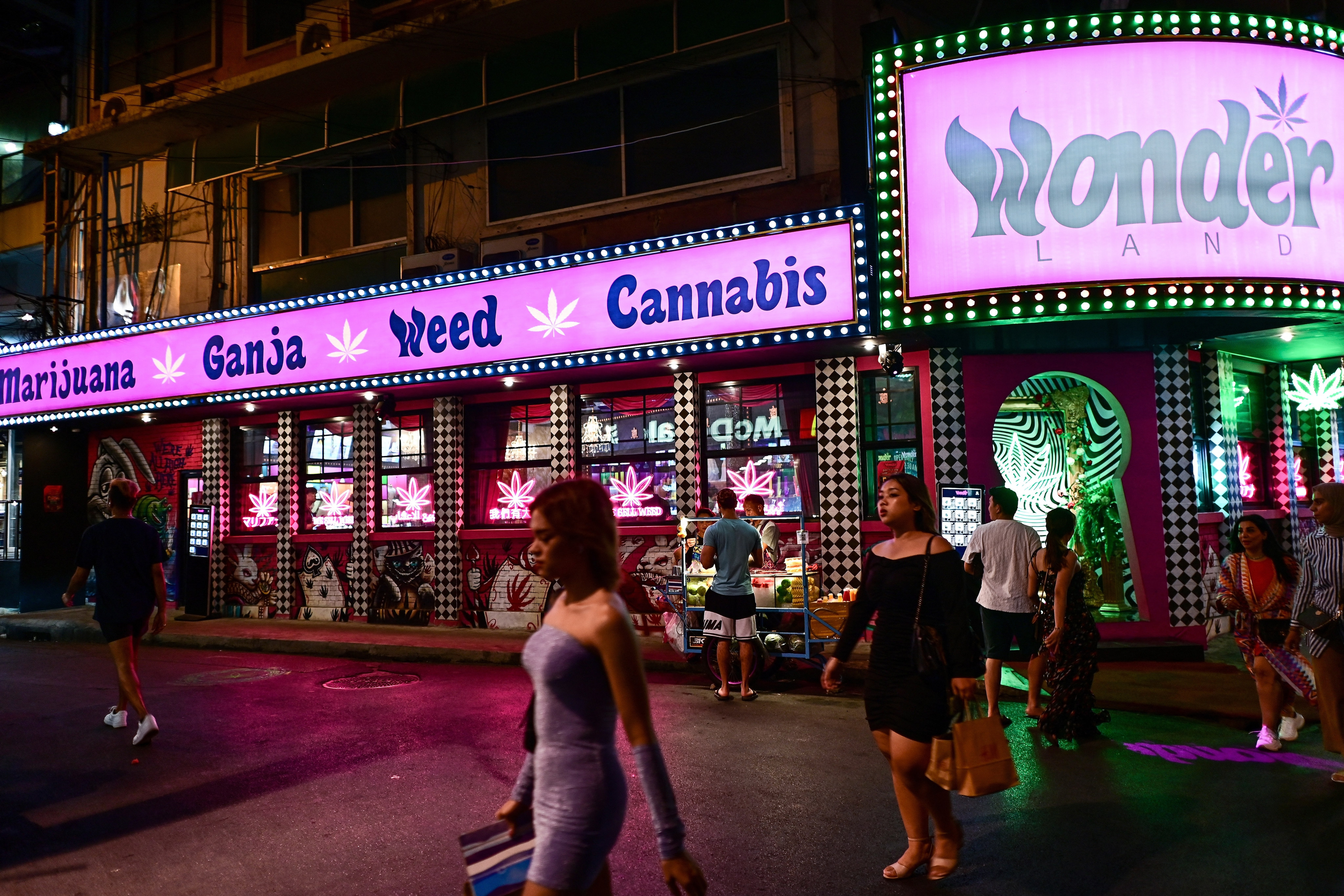 People walk past a cannabis dispensary in the Sukhumvit area of Bangkok. The drug’s decriminalisation has drawn recreational cannabis users to Thailand, but the next government plans to reclassify the drug as a narcotic. Photo: AFP