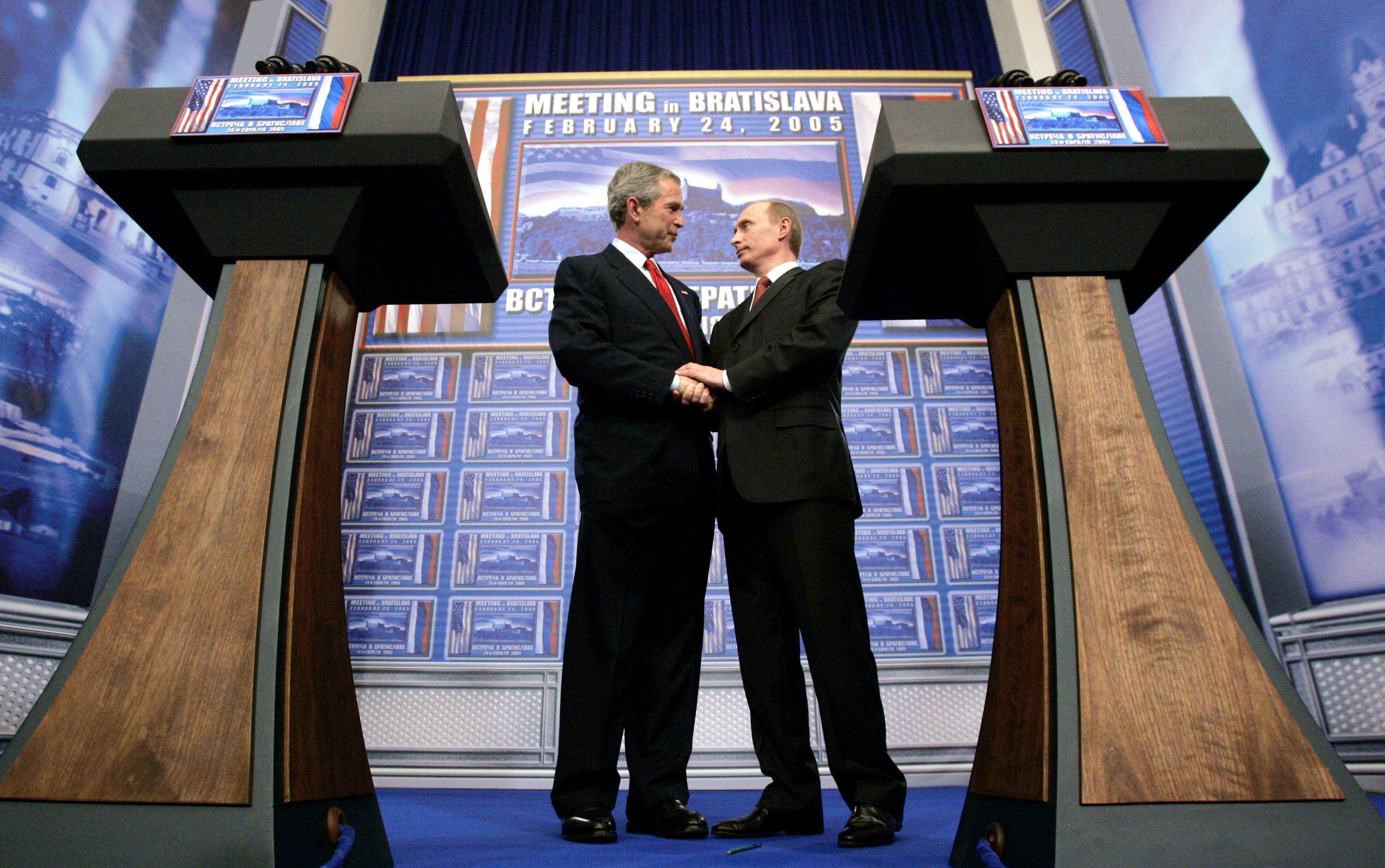 Then US president George W. Bush and Russian President Vladimir Putin clasp hands after conducting a joint press conference at Bratislava Castle in Slovakia, on February 24, 2005. While US-Russia tries have deteriorated in recent years, Putin was the first international leader to call Bush after the September 11 attacks. Photo: Reuters