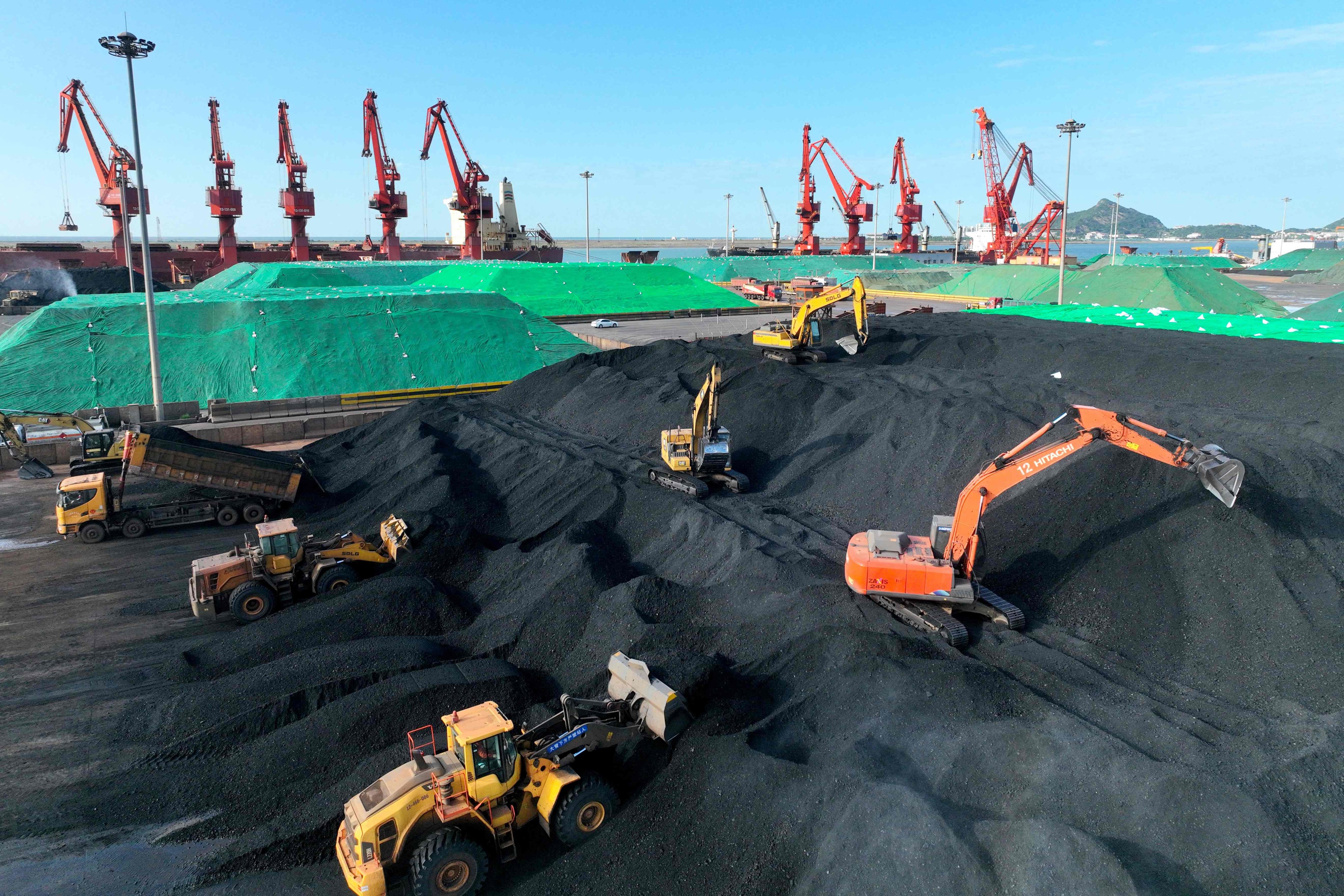 Excavators transfer coal at a port in China’s Jiangsu province. The country has ramped up coal power supplies since the hydropower crisis in Sichuan province last summer. Photo: AFP