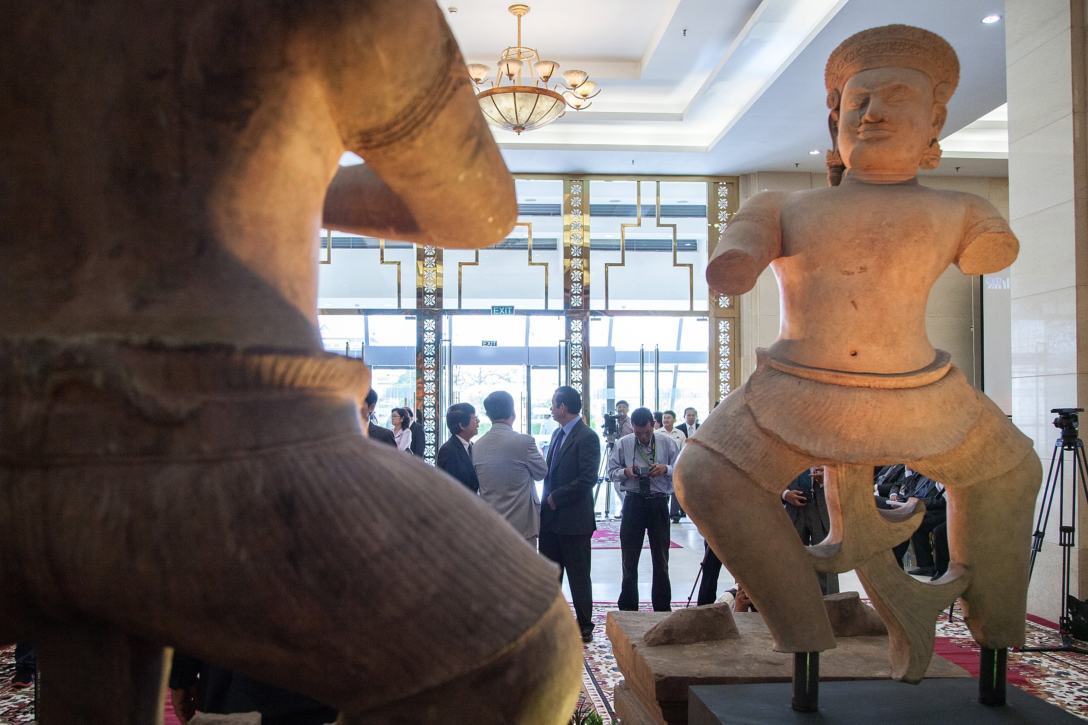 PHNOM PENH, CAMBODIA - JUNE 03:  The Bhima (left) and the Duryodhama (right) statues are displayed during a ceremony to handover three statues back to Cambodia at the Council of Ministers on June 3, 2014 in Phnom Penh, Cambodia. The Bhima statue is unveiled during an official ceremony at the Council of Ministers in Cambodia. It is one of several statues looted from the Koh Ker temple complex in Cambodia in the 1970s, ending up in private collections and in museums in the United States, which represent key figures from the Mahabharata, a Sanskrit epic describing a wrestling match between ancient warriors. The Norton Simon Museum announced on May 3rd that it would repatriate the Bhima statue, which it acquired from a New York art dealer in 1976, to Cambodia. The Bhima statue is joined by two other statues from the Prasat Chen temple also recently returned to Cambodia: the Duryodhana and the Balarama, which are being returned by auction houses Sotheby’s and Christie’s.  (Photo by Omar…