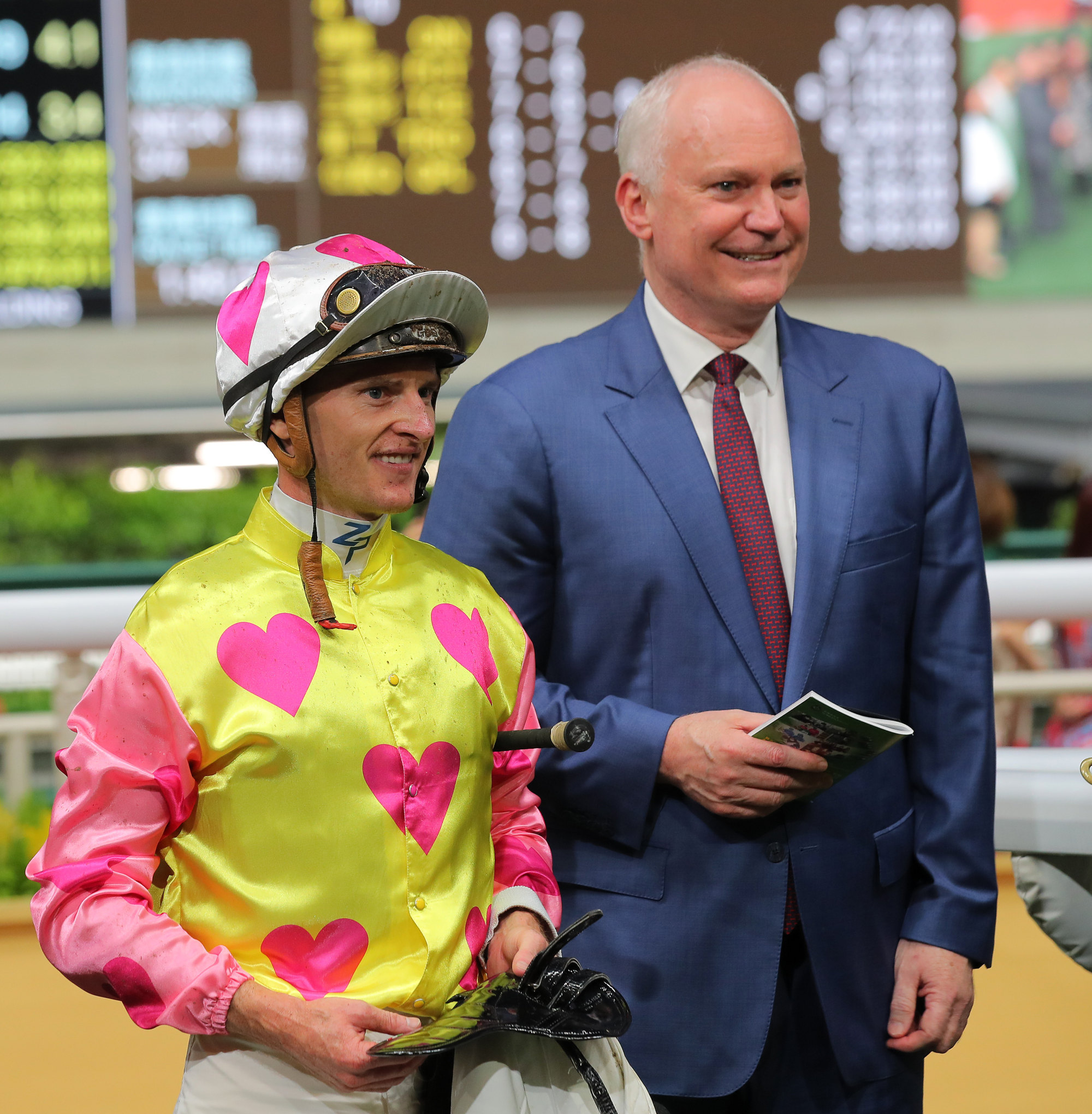 Jockey Zac Purton and trainer David Hall celebrate the victory of Management Folks at Happy Valley on Wednesday.