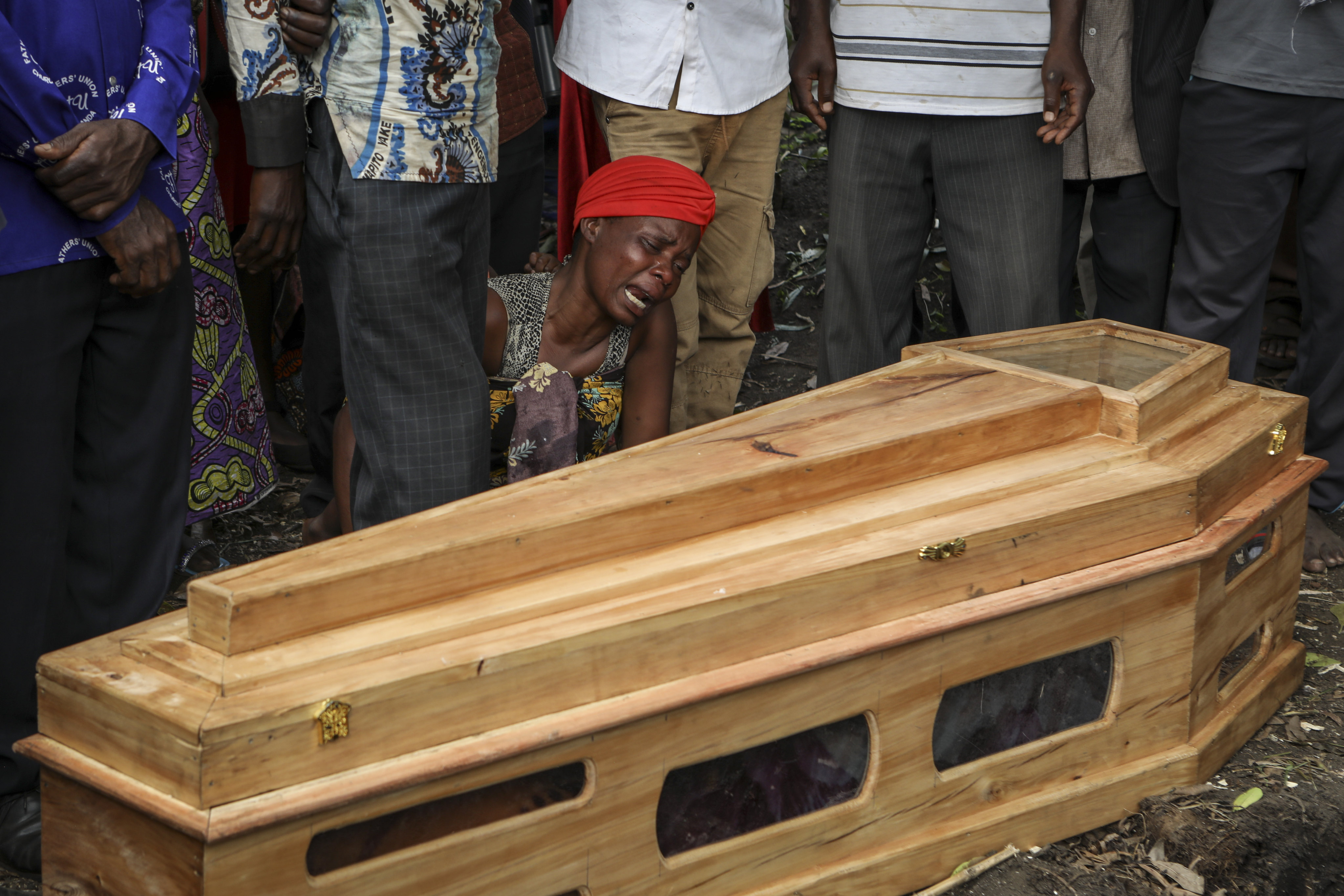 Relatives mourn as a victim of the attack by suspected rebels us buried in Nyabugando, Uganda. Photo: AP