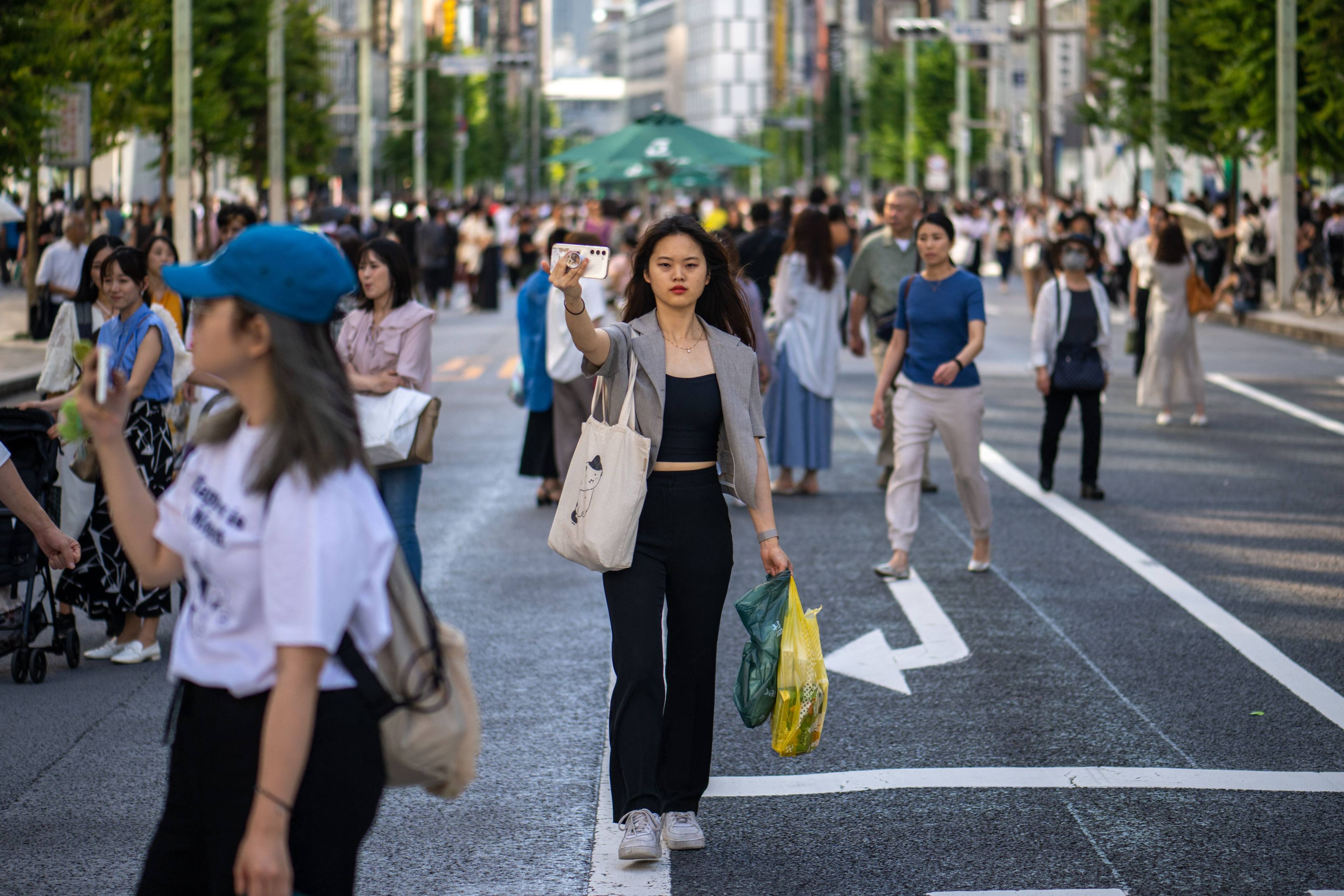 Pedestrians walk through the Ginza district of Tokyo on June 17. Buyers get more bang for their buck in Japan’s capital, compared with Hong Kong, Singapore, London and New York. Photo AFP