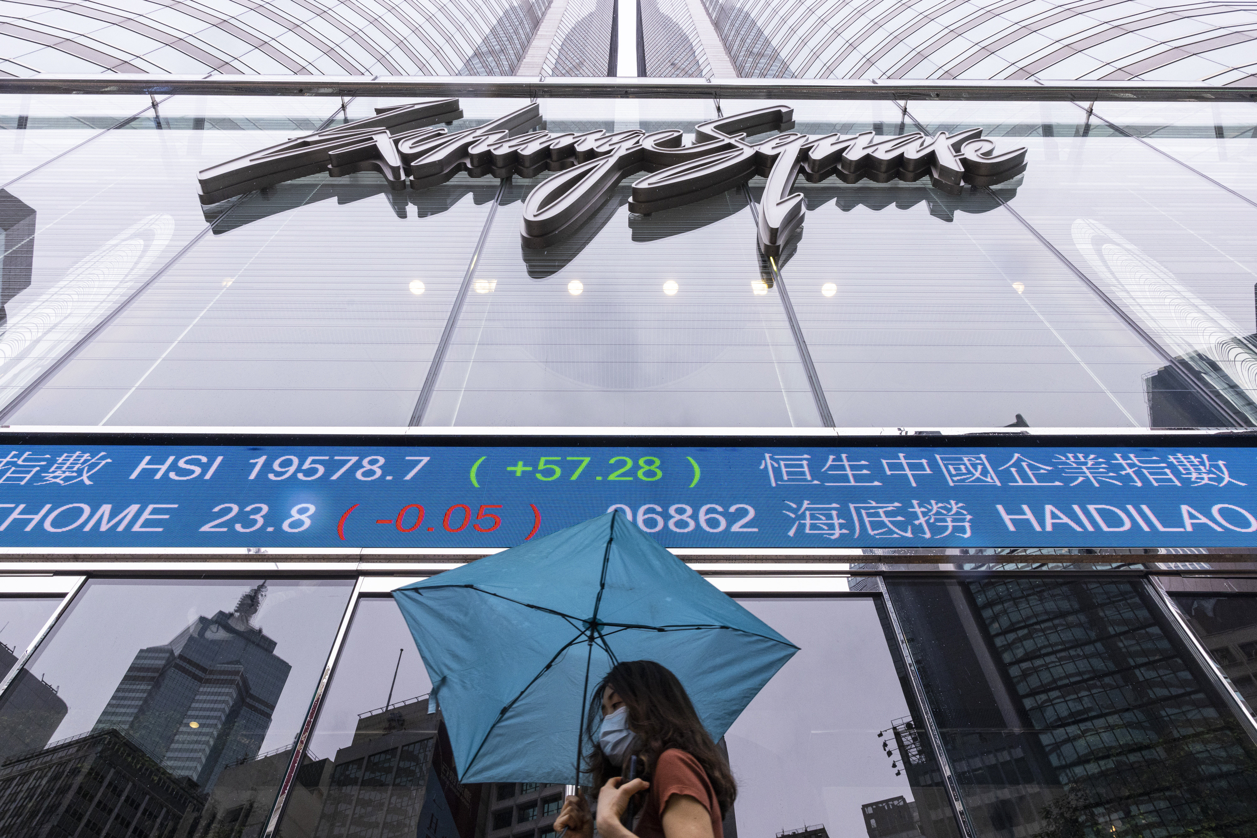 A pedestrian passes by the Hong Kong stock exchange’s home base of Exchange Square in Hong Kong on June 14, 2023. Photo: AP
