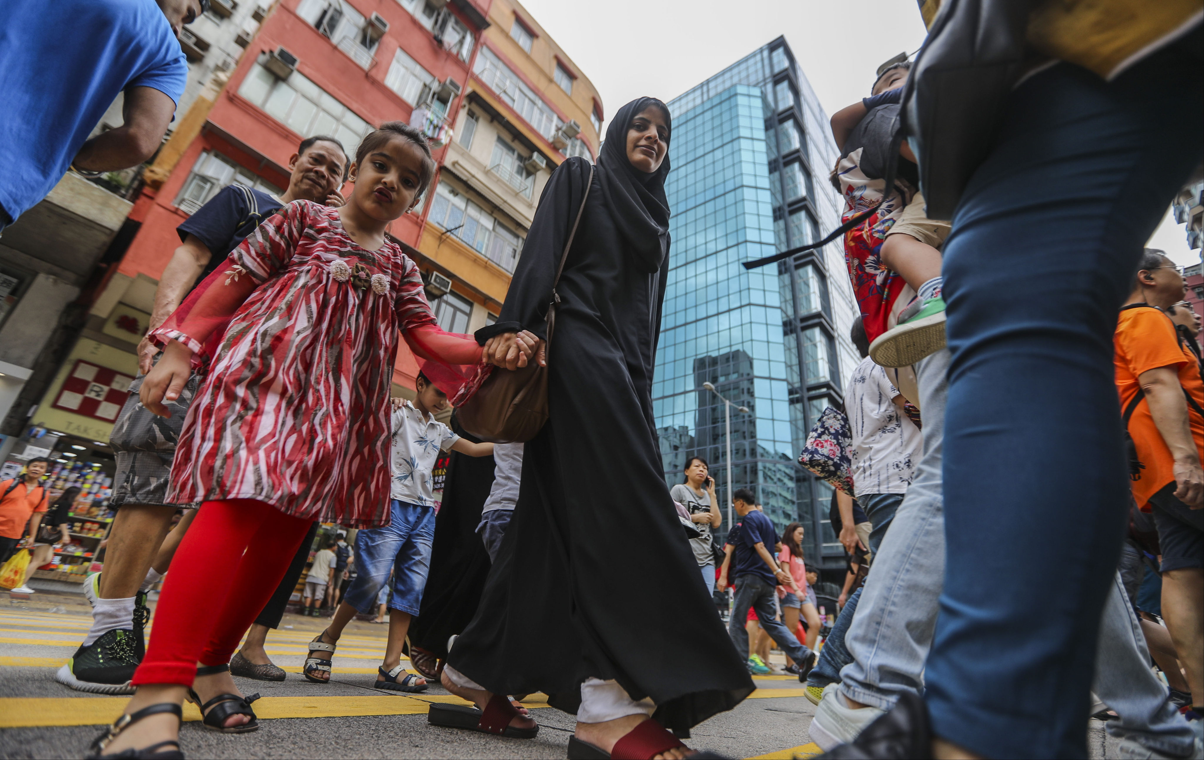 People cross the road in Sham Shui Po, Hong Kong in 2018. All children, irrespective of their ethnicity and cultural background, deserve equal opportunity in education. Photo: Edward Wong 