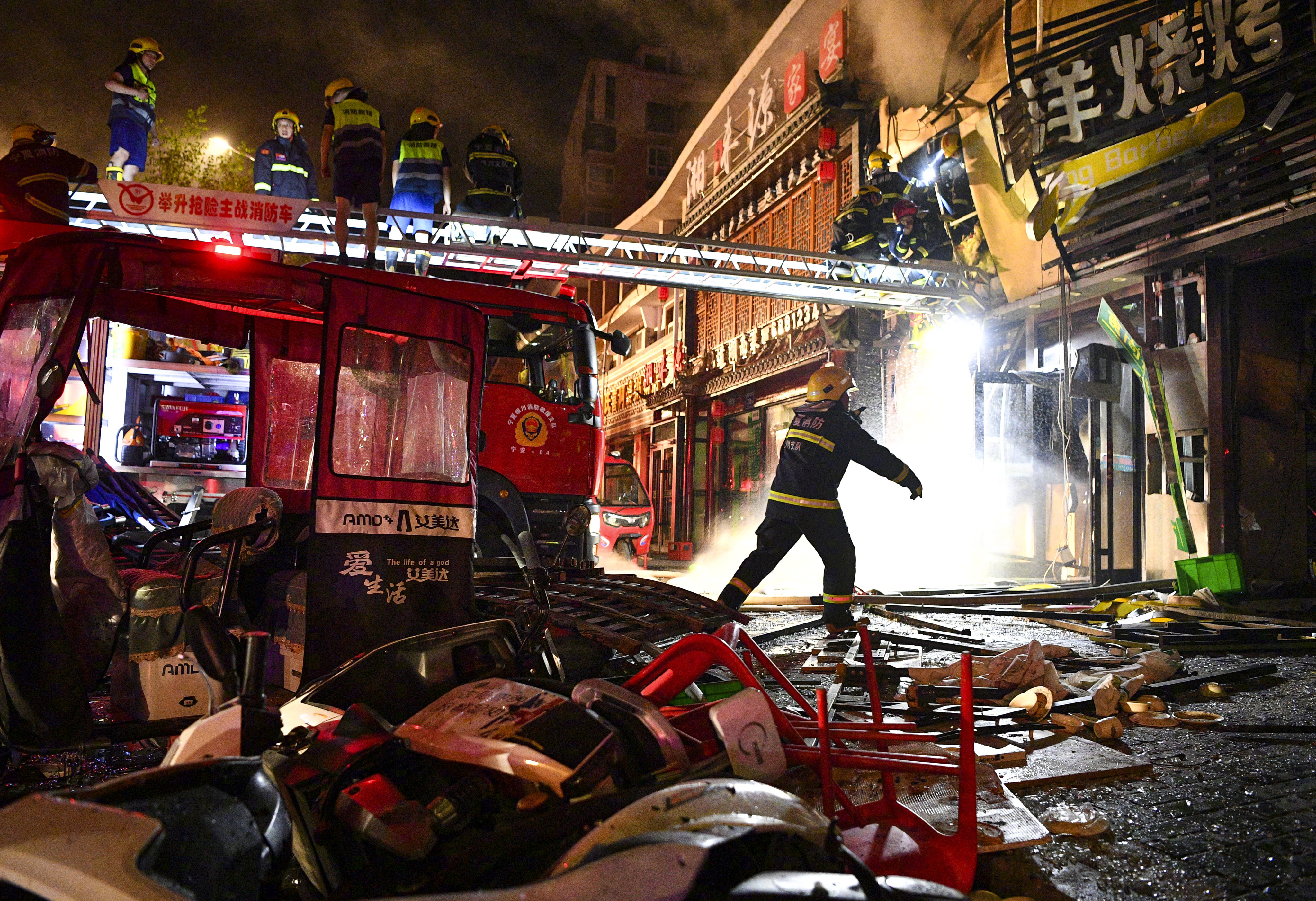 Firefighters at the scene of the shattered barbecue restaurant in Ningxia, China on Wednesday night. Photo: Xinhua