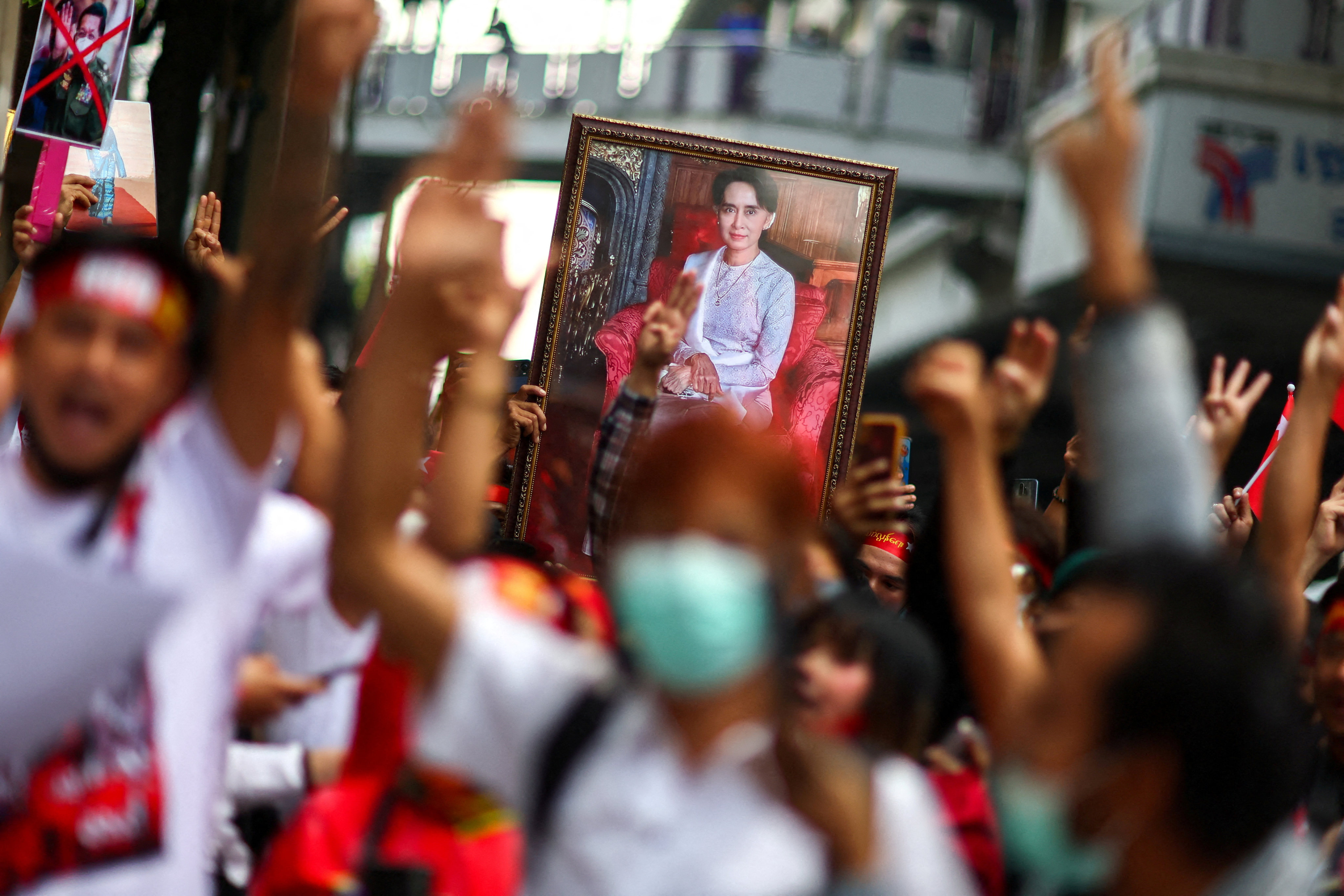 Protesters hold up a portrait of Aung San Suu Kyi and raise three-finger salutes, during a demonstration to mark the second anniversary of Myanmar’s 2021 military coup, outside the embassy of Myanmar in Bangkok, Thailand, on February 1, 2023. Photo: Reuters