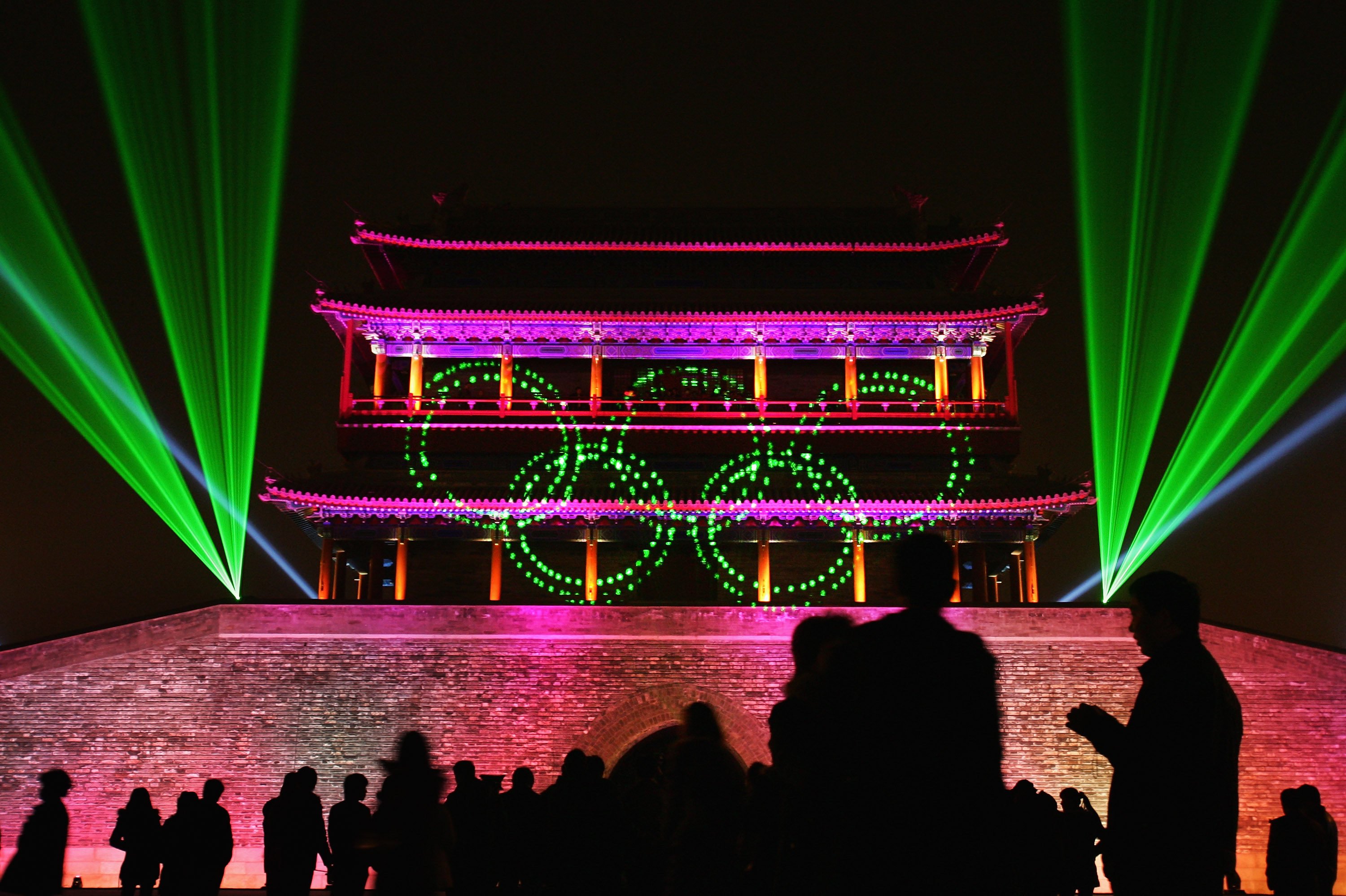 Visitors look at a laser performance in front of the Yongdingmen, or central south gate, in Beijing, rebuilt in 2003. The city is seeking Unesco World Heritage status for a large area of its former imperial inner city, including this gate. Photo: Getty Images
