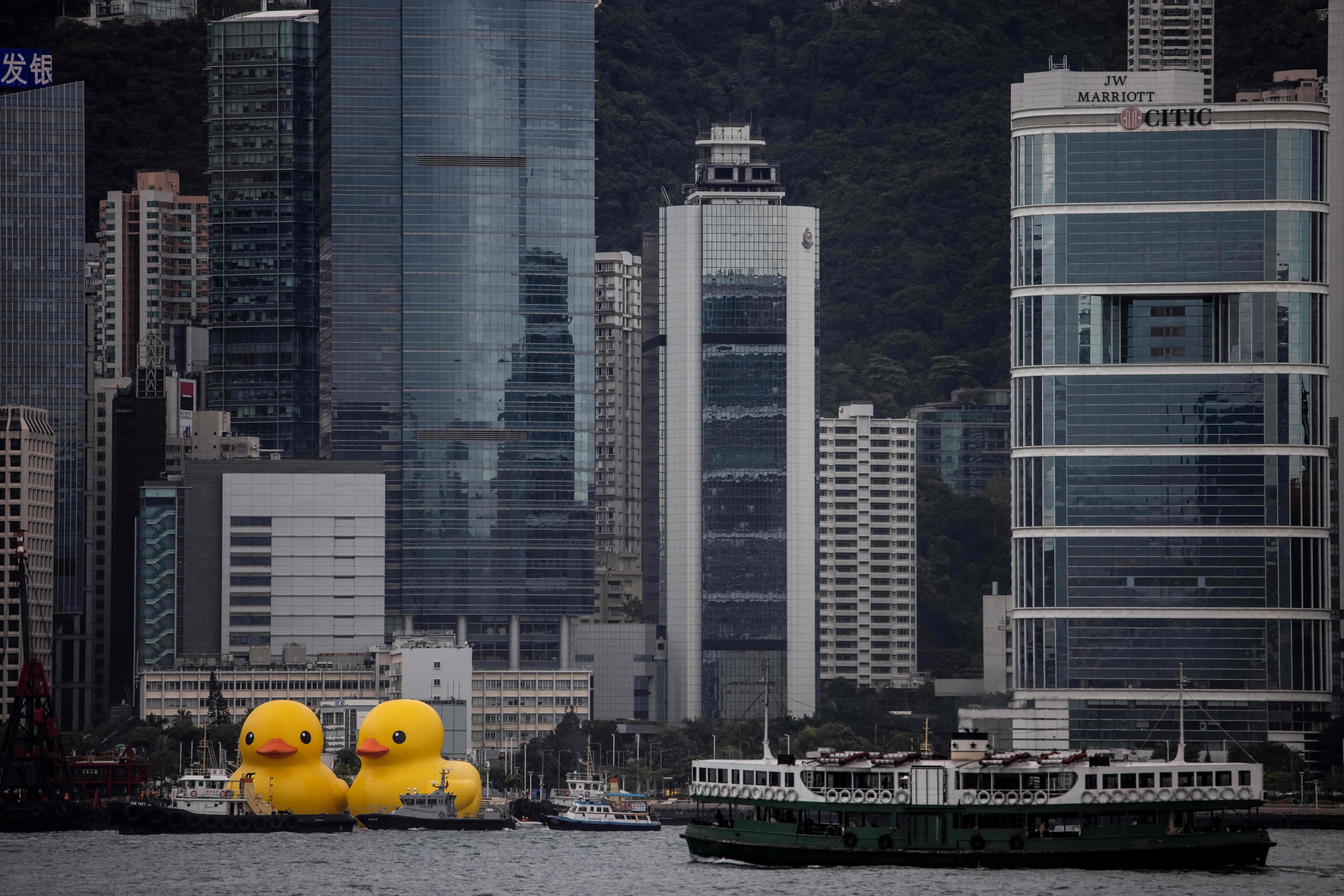 Two large inflatable yellow ducks are seen in Hong Kong’s Victoria Harbour on June 9, as part of a public art exhibition. Compared to the older generations, young people today tend to prioritise work-life balance, travel and entertainment over a strong work ethic. Photo: AFP