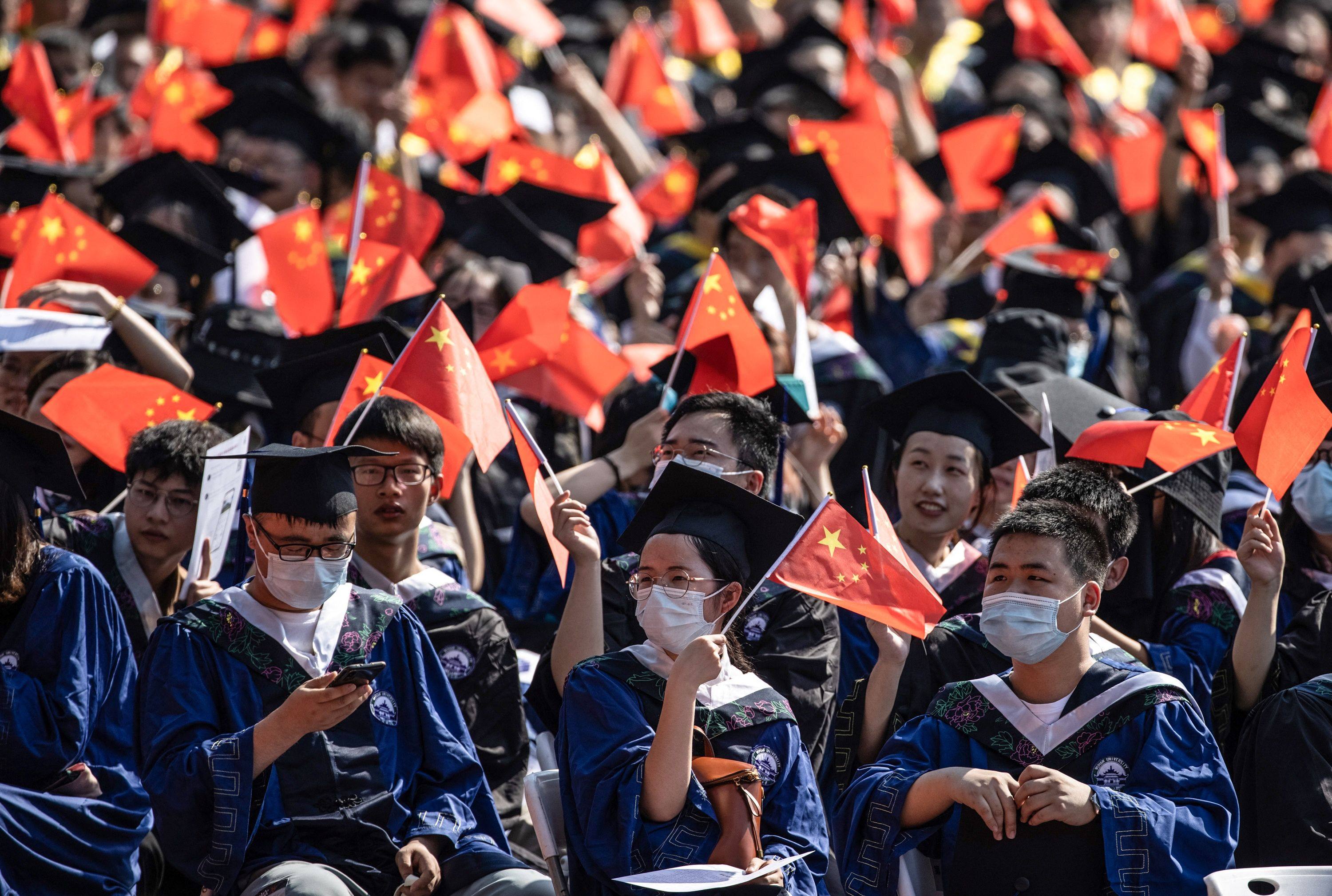 Graduates of a university in Wuhan, China attend a graduation ceremony on Friday. Photo: STR/AFP