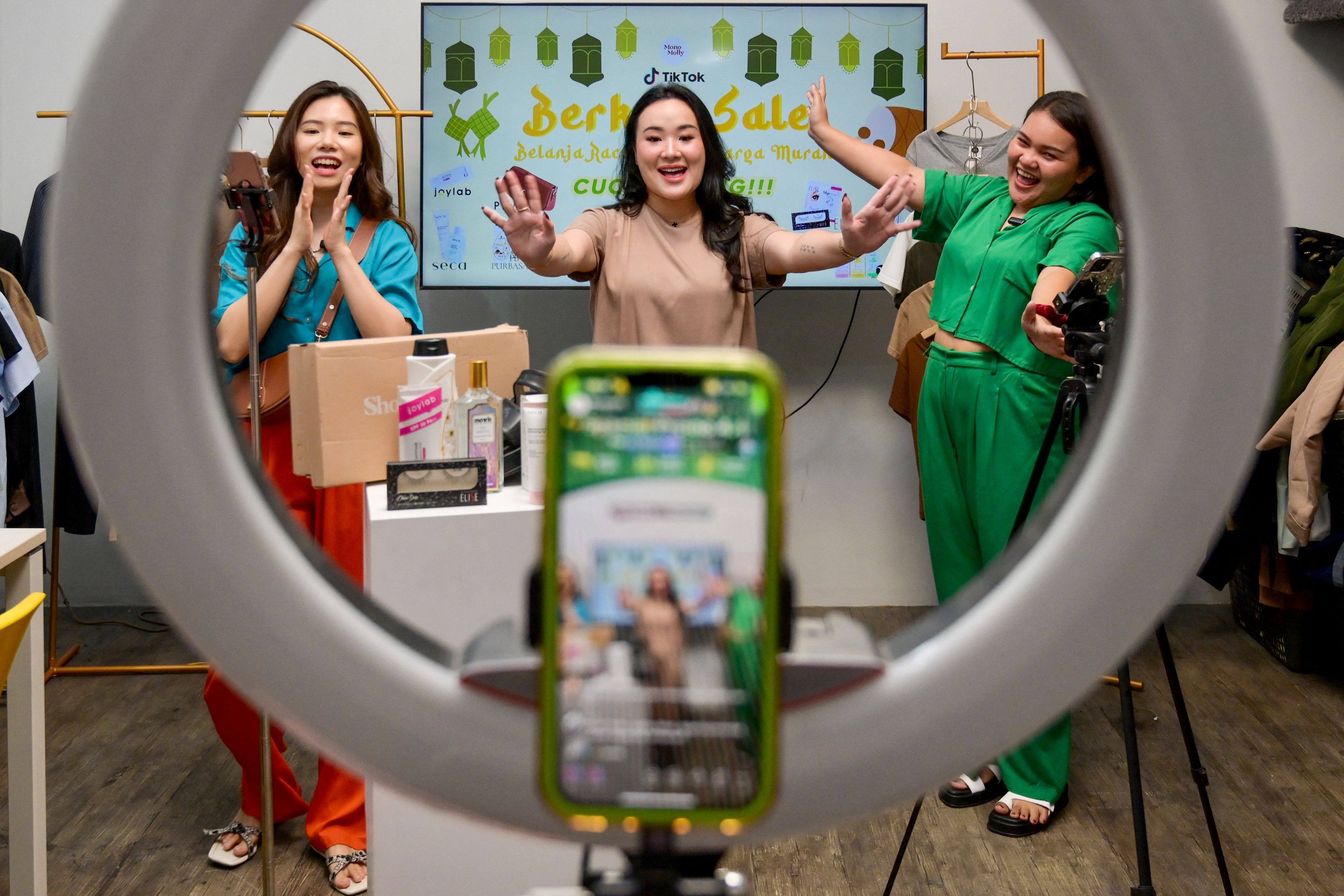 Christine Febriyanti, centre, owner of a TikTok sales channel called Monomolly, and her employees offering merchandise through a TikTok livestream at a room in Jakarta. Photo: AFP