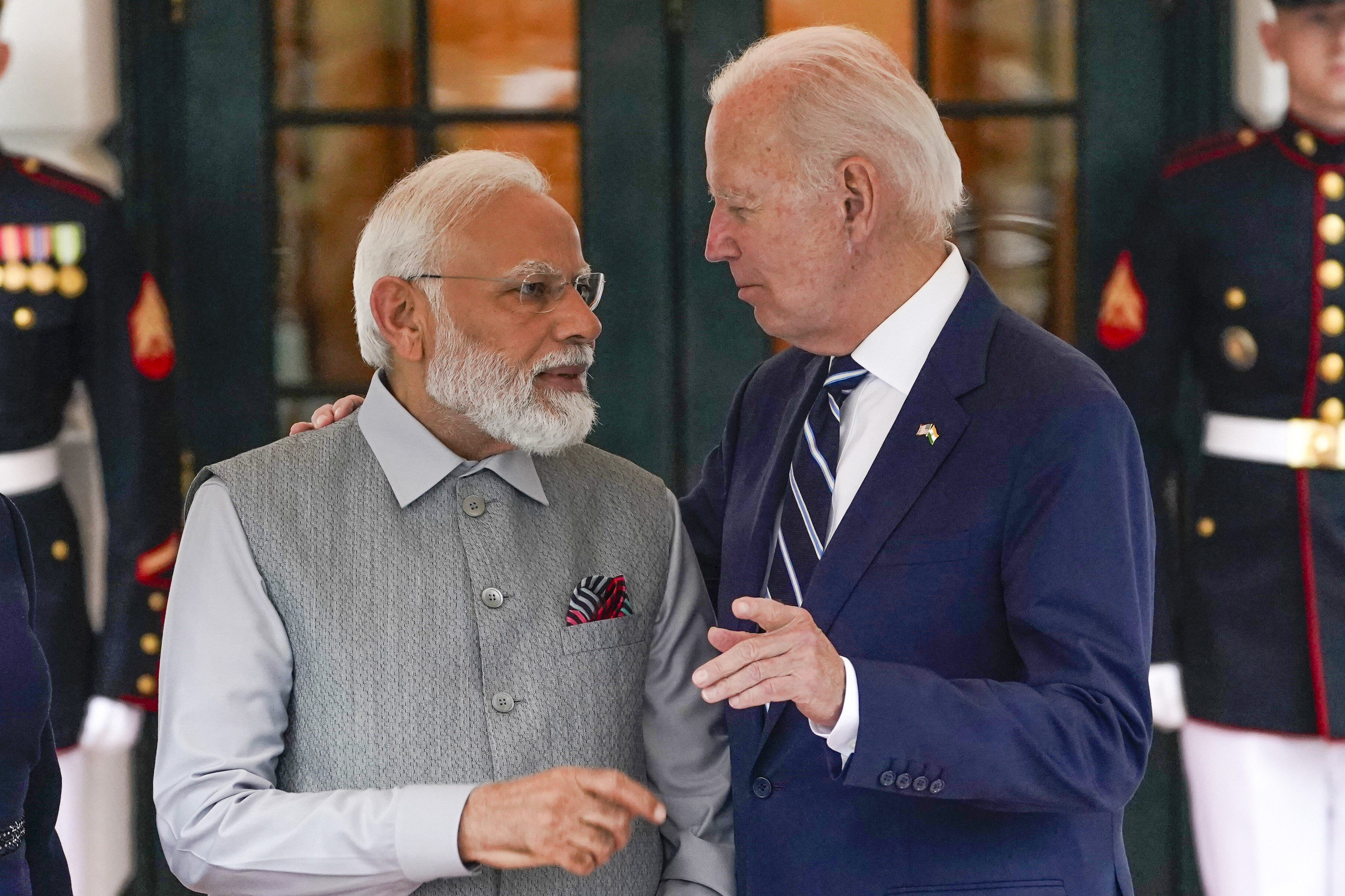 US President Joe Biden talks with India’s Prime Minister Narendra Modi as he arrives at the White House for a private dinner on June 21, 2023, in Washington.