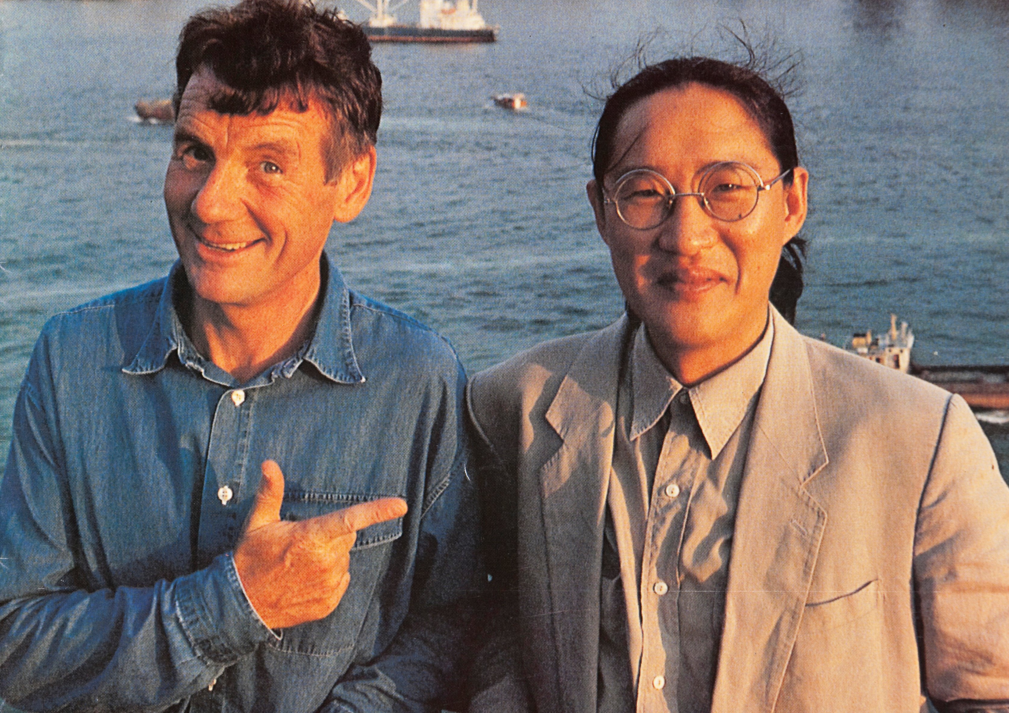 This handout image received on 21 October 2013 shows photographer Basil Pao and TV presenter Michael Palin posing for a photograph in Hong Kong Full Circle launch, a photography book by Pao, in 1996.  21OCT13  ÔøºMP and BP in Hong Kong for Full Circle launch in 1996. (Photo by )