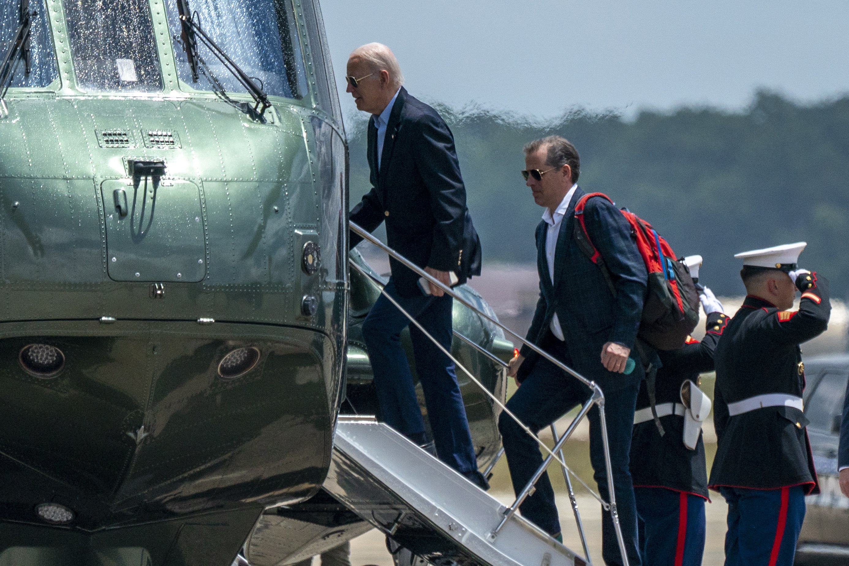 US President Joe Biden, left, and his son Hunter boarding Marine One at Joint Base Andrews, Maryland, on Saturday. Biden was briefed on the situation in Russia. Photo: EPA-EFE