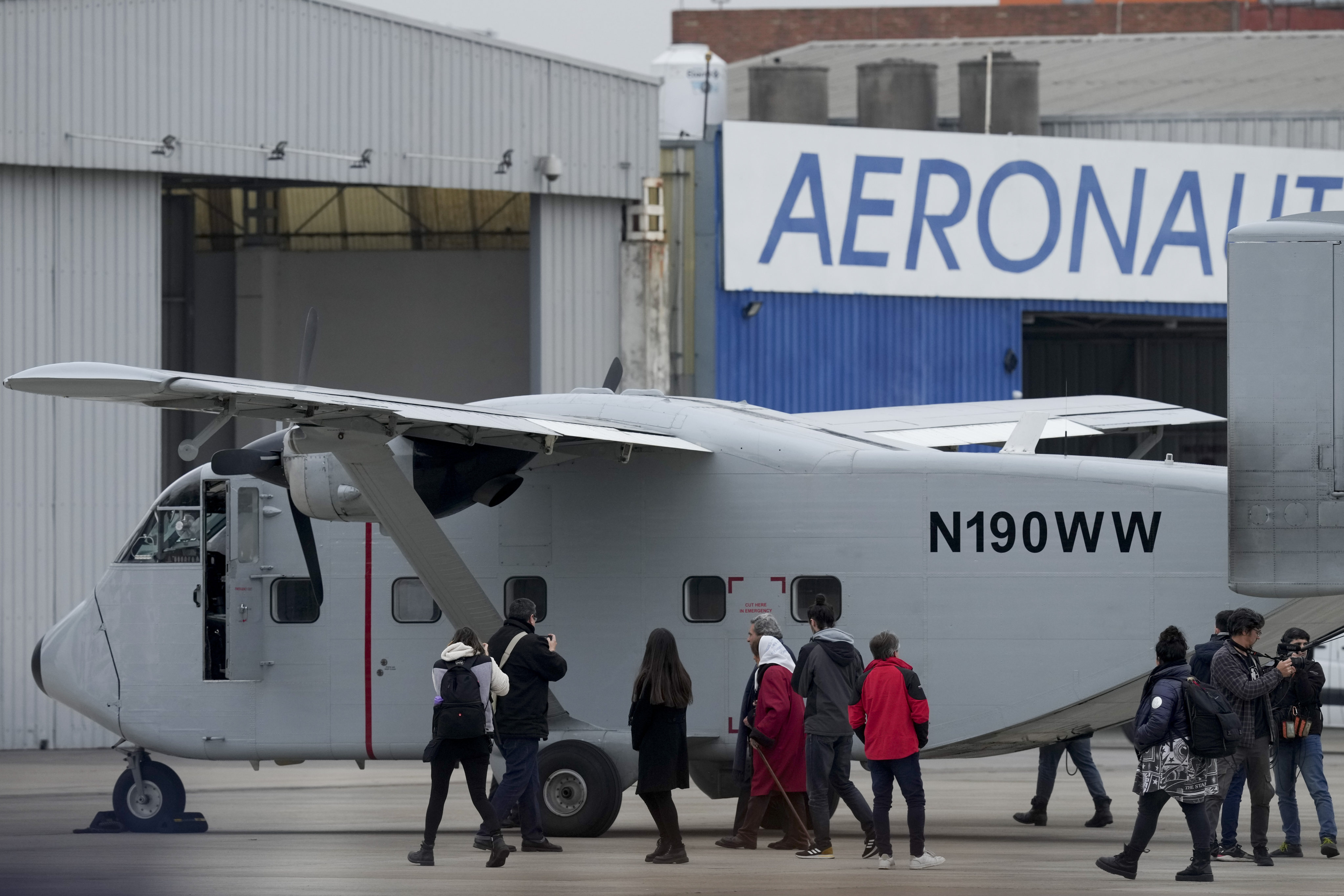 Members of human rights organisations walk alongside one of the planes that carried out “death flights”, when detainees were tossed out into the sea during Argentina’s last military dictatorship, on the tarmac of the Jorge Newbery international airport in Buenos Aires, Argentina on Saturday. Photo: AP