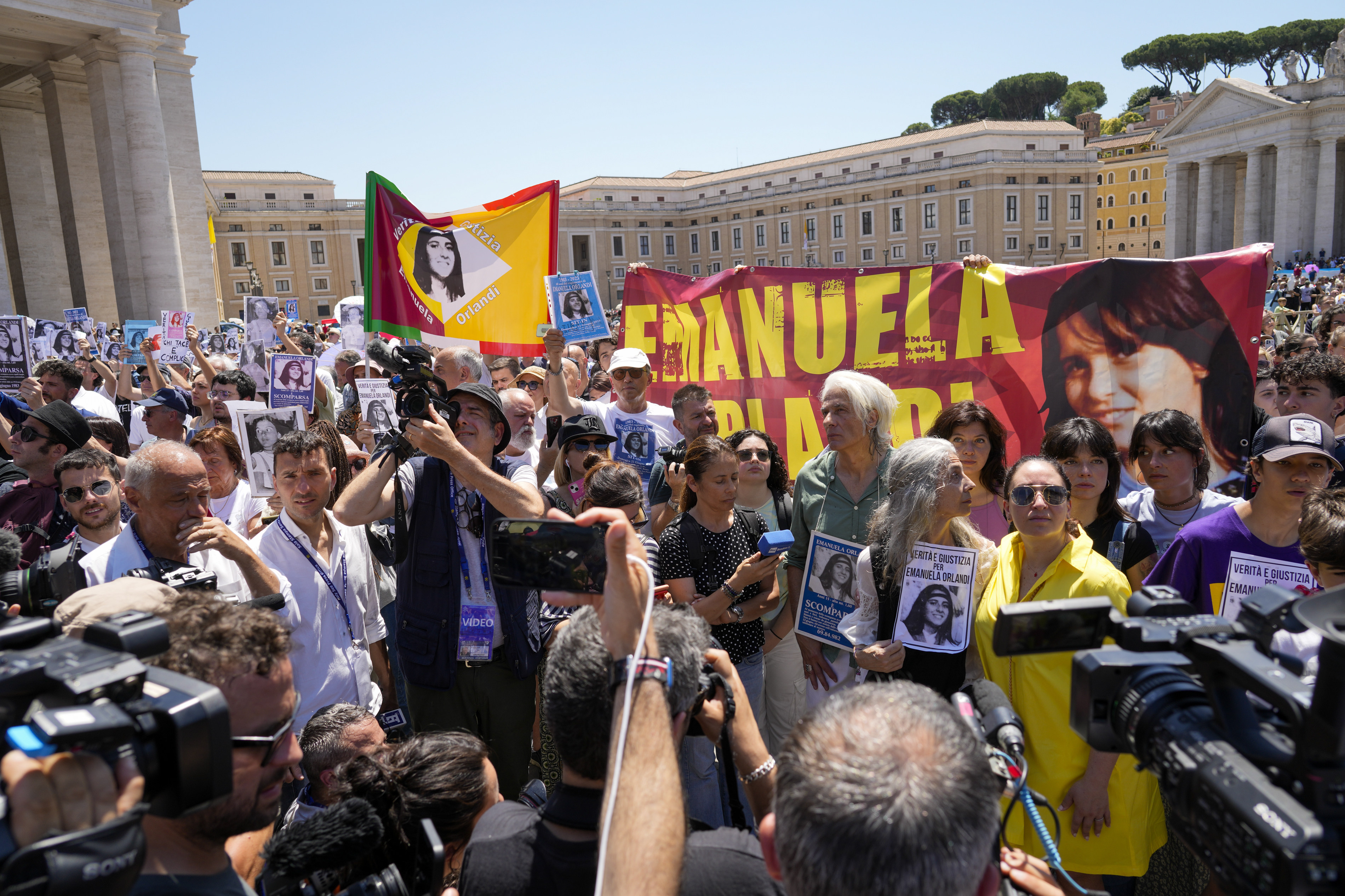 People hold pictures of missing teen Emanuela Orlandi during a sit-in in St Peter’s Square as Pope Francis recites noon prayers at the Vatican on Sunday. Photo: AP