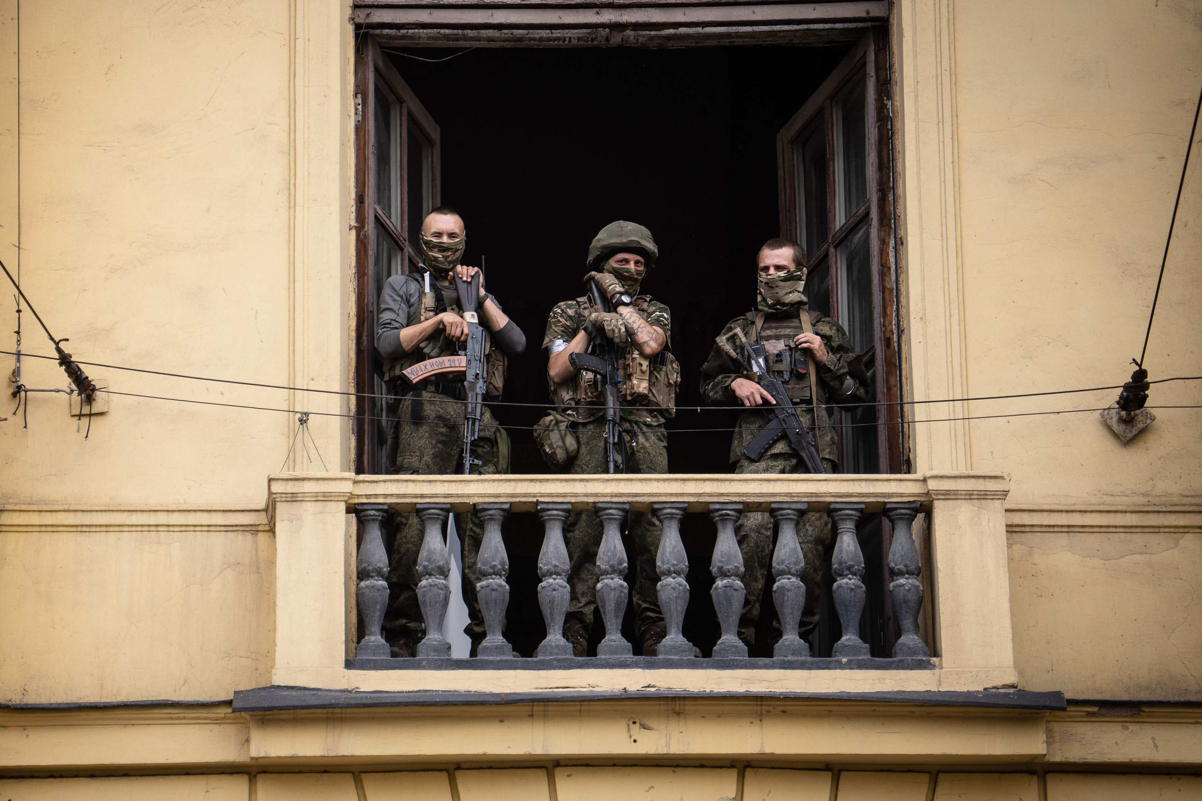 Members of the Wagner group stand on the balcony of the circus building in Rostov-on-Don, Russia, on June 24.  Yevgeny Prigozhin, commander of the mercenary group, had ordered his troops to march on Moscow but abruptly reached a deal with the Kremlin to go into exile and sounded the retreat on June 25. Photo: AFP