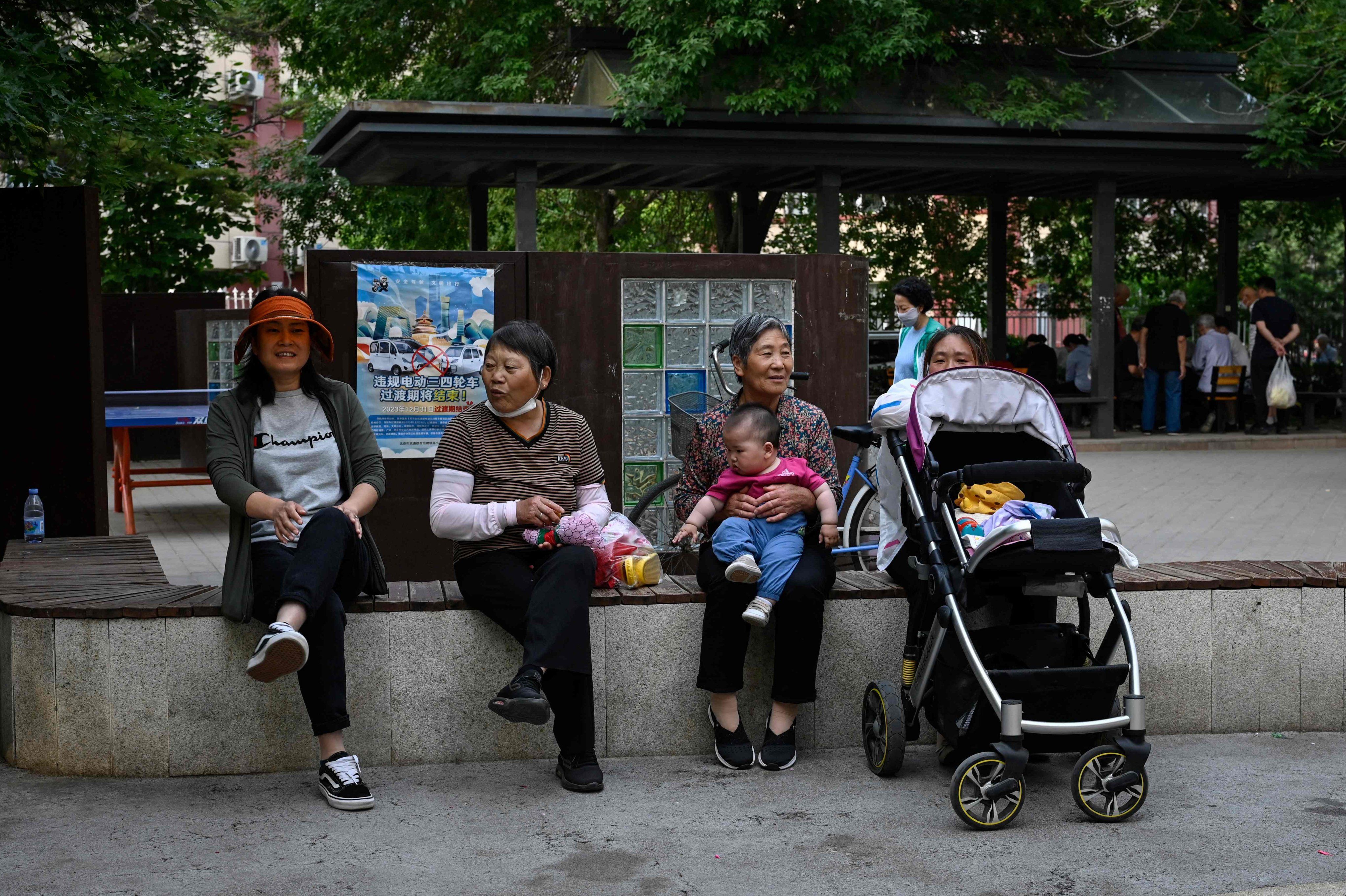 People relax on a bench at a residential compound in Beijing on May 26, 2023. Photo: AFP